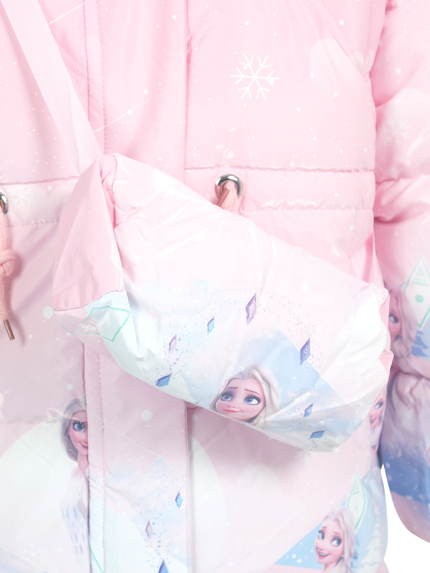 Close-up of a light pink winter jacket with white snowflake patterns, featuring a matching crossbody bag printed with Frozen character Elsa and diamond-shaped motifs
