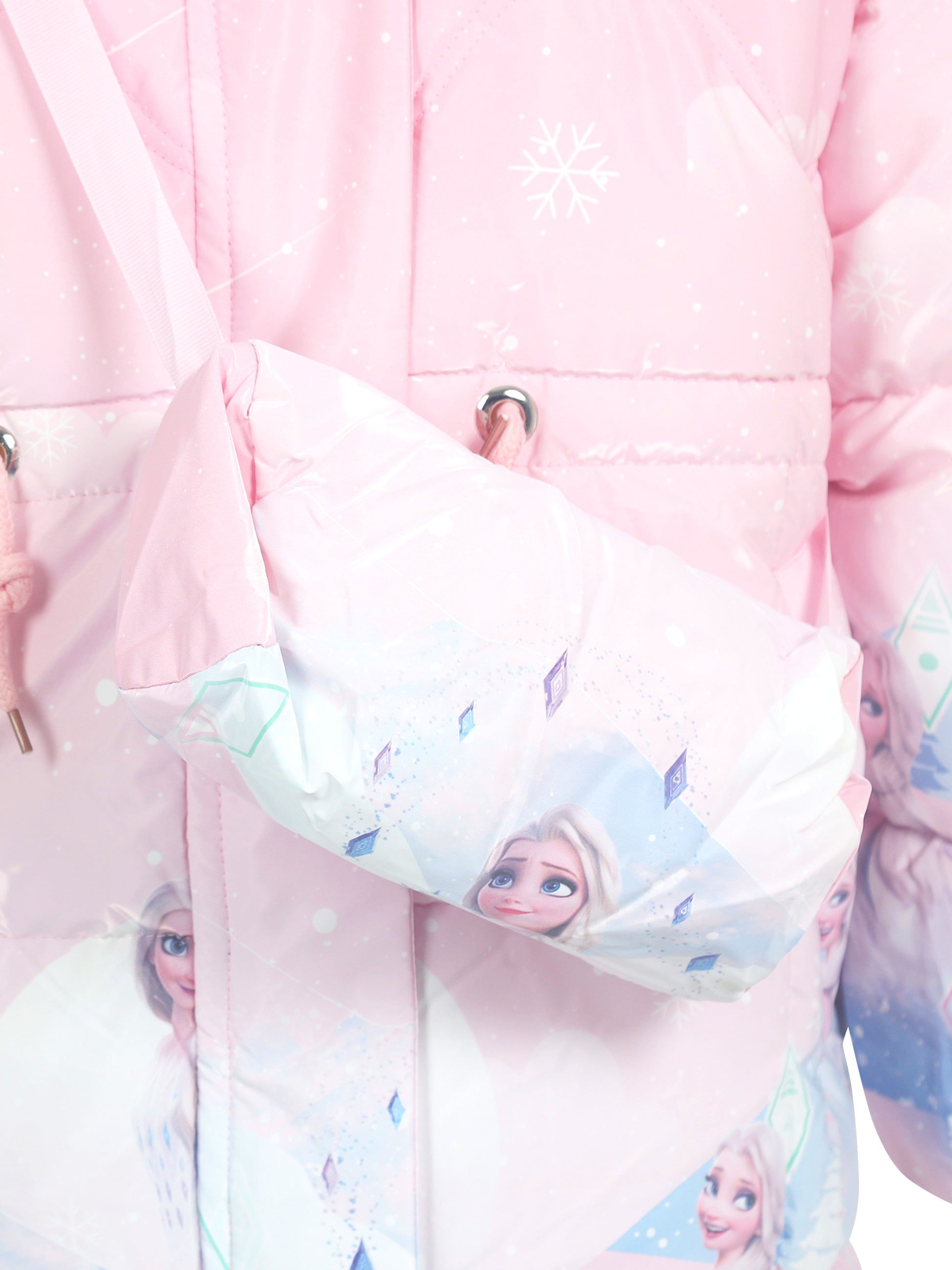 Close-up of a light pink winter jacket with white snowflake patterns, featuring a matching crossbody bag printed with Frozen character Elsa and diamond-shaped motifs