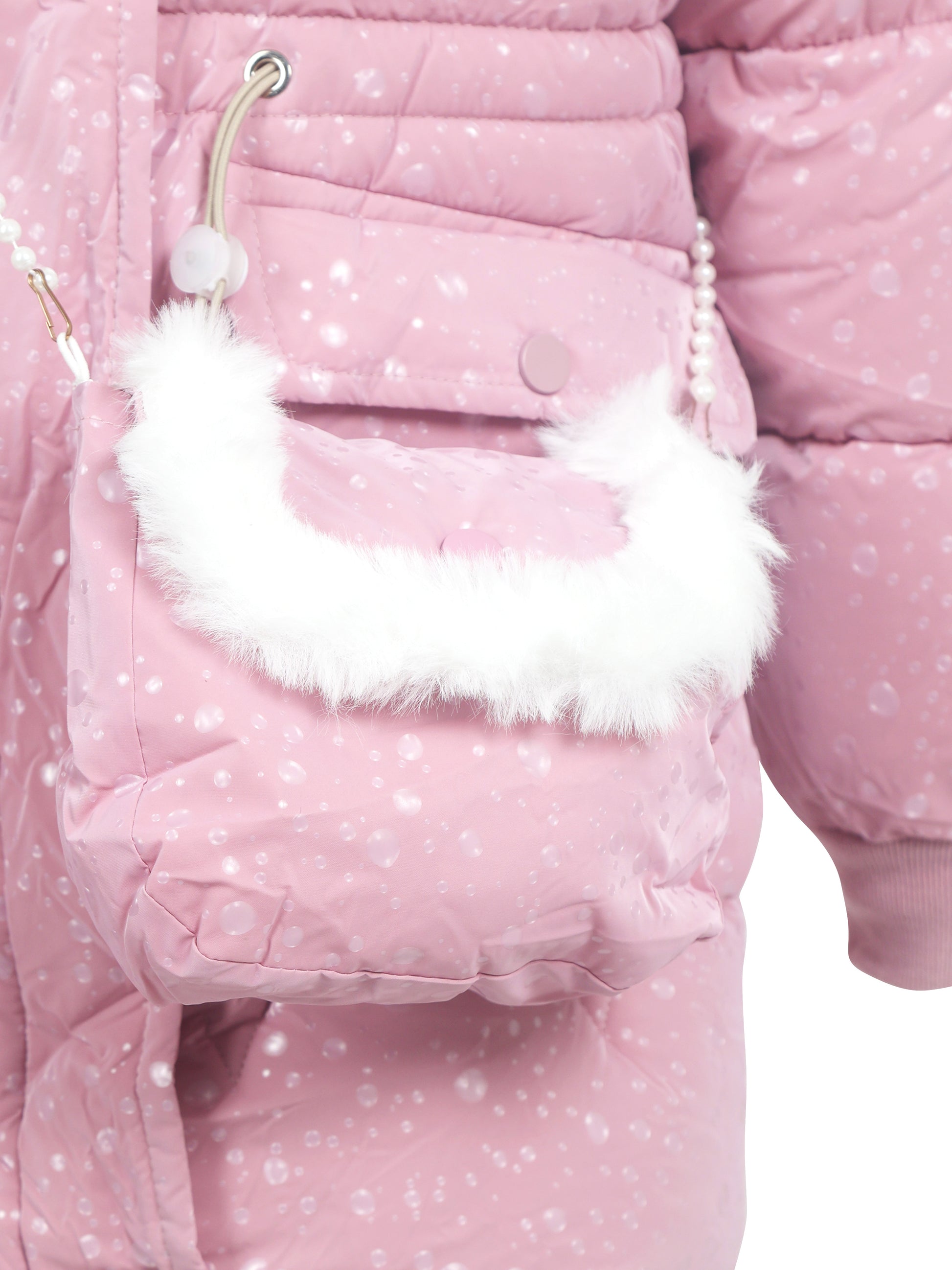 Close-up of a light pink winter coat pocket with matching detachable bag, featuring a white faux fur trim and pearl strap, with visible water droplets on the fabric.