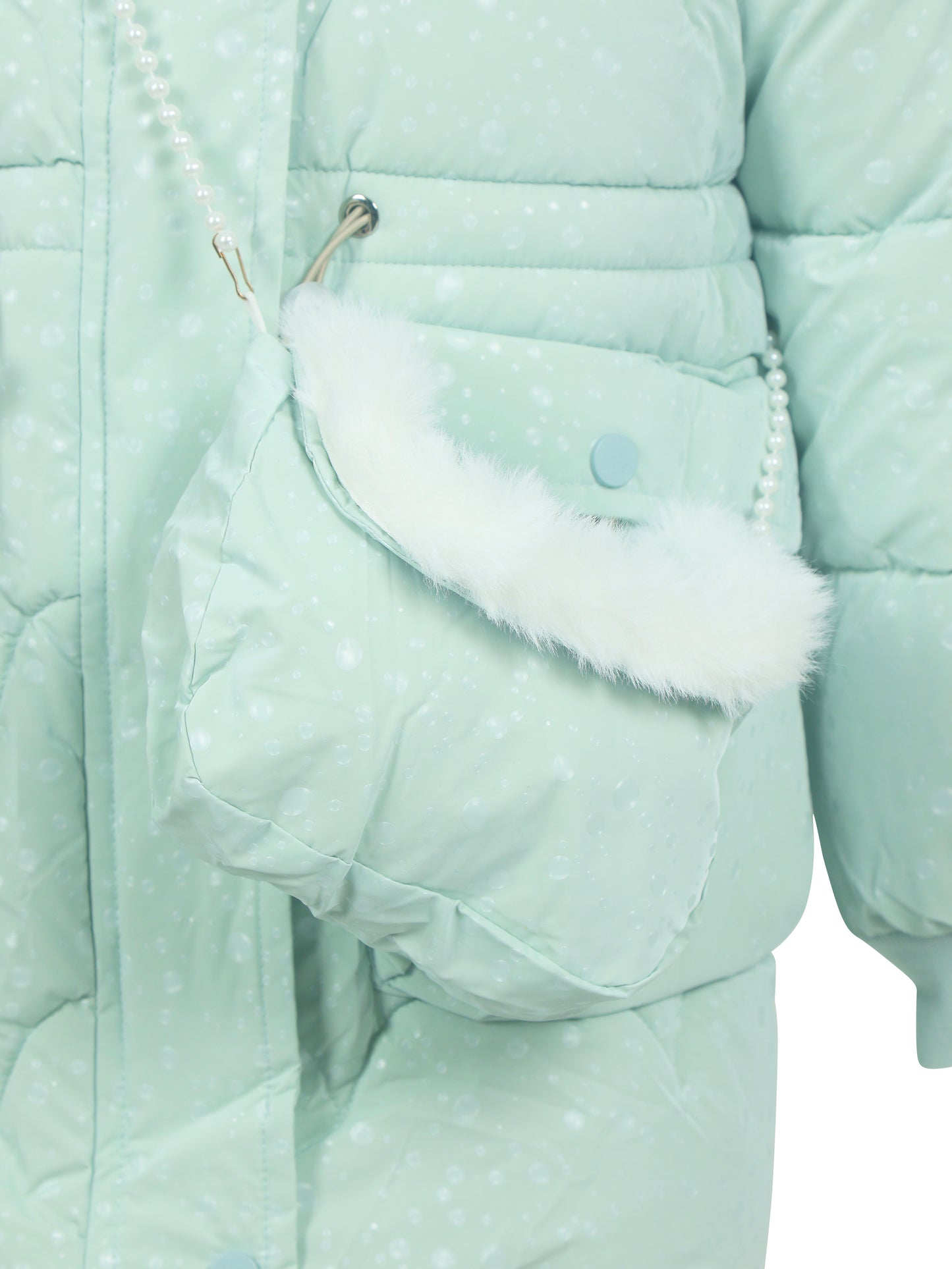 Close-up of a mint green padded winter coat with a matching crossbody bag featuring a white faux fur trim and pearl strap