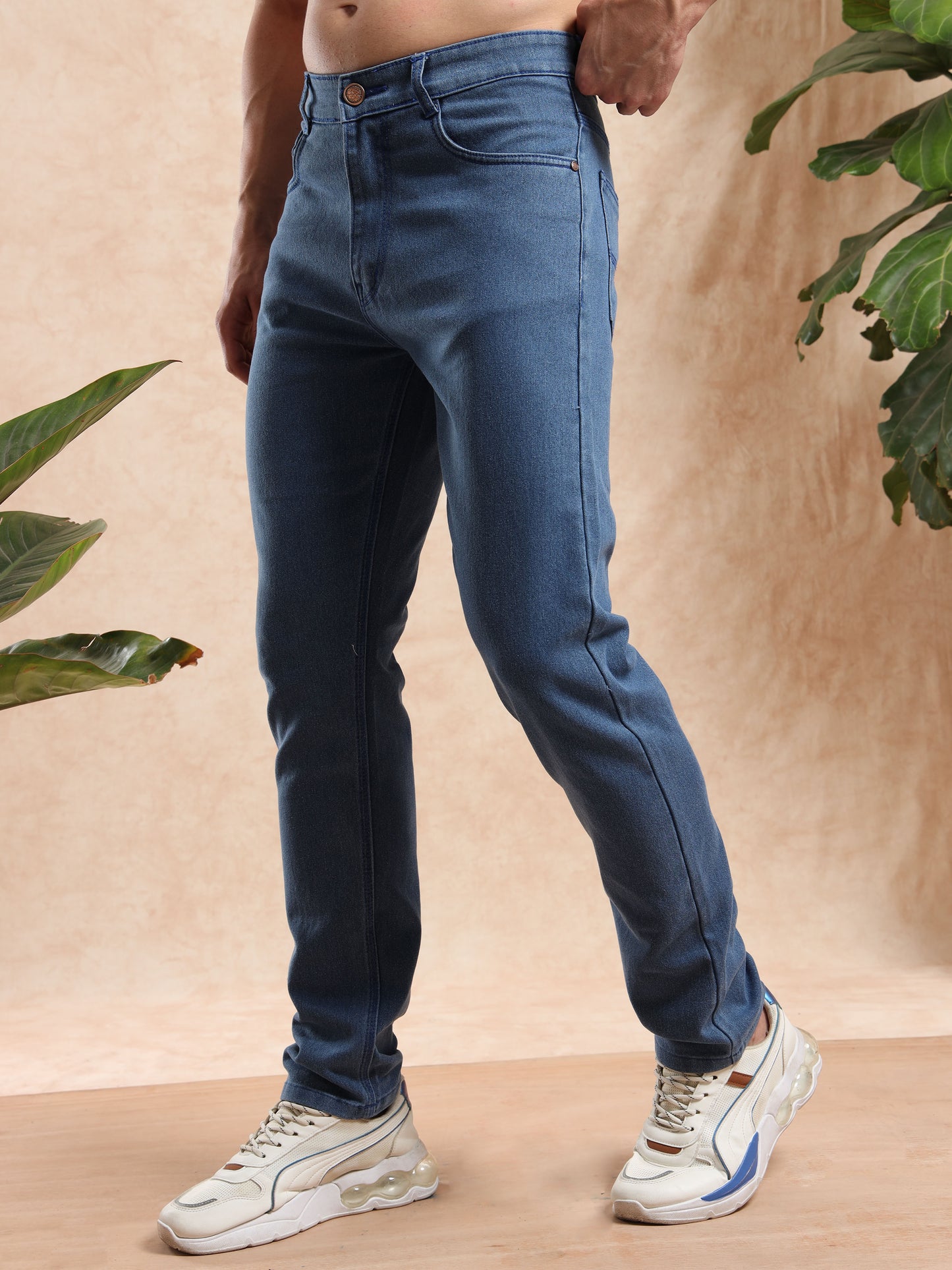 men’s slim fit blue jeans paired with casual sneakers