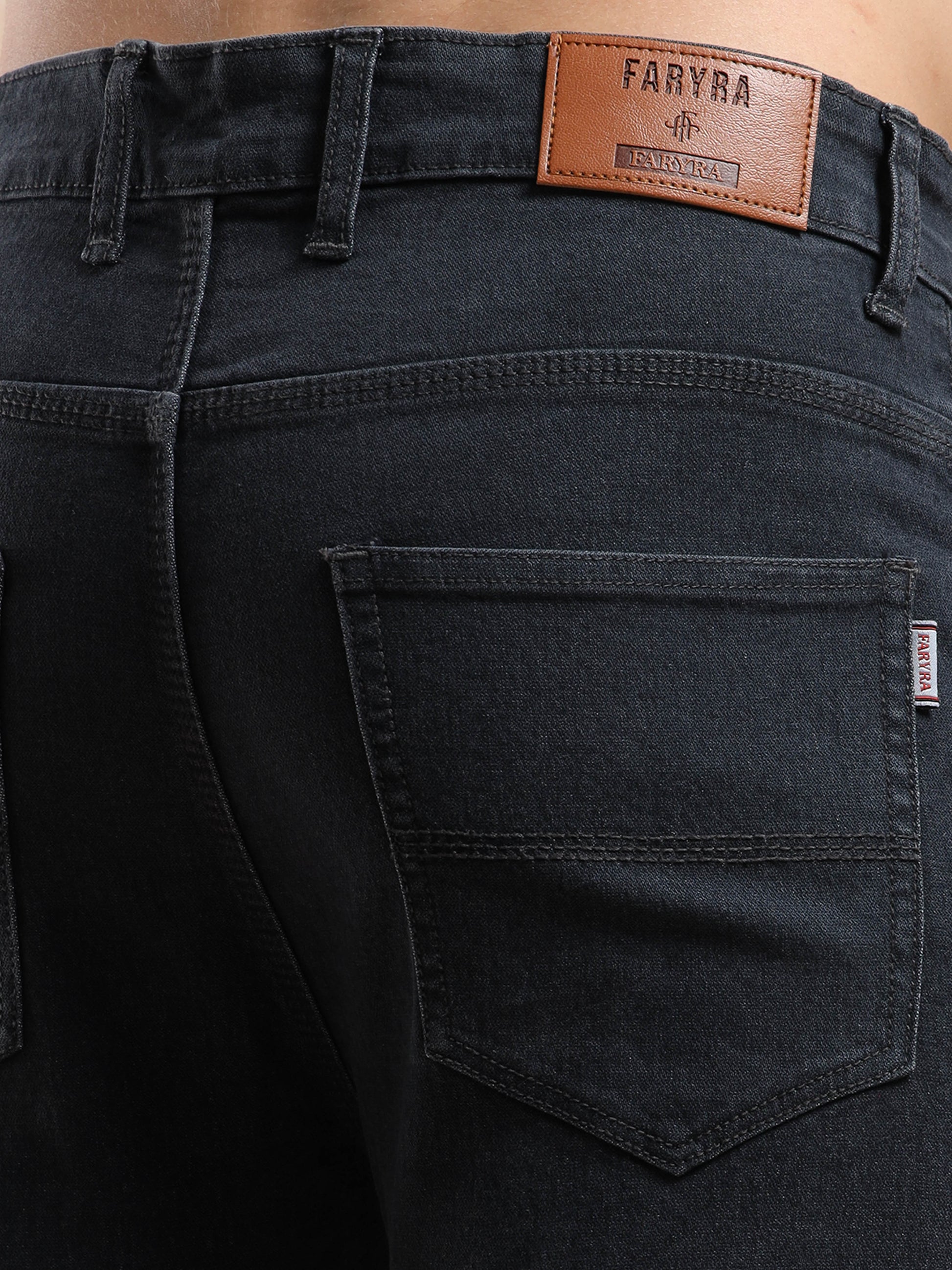 Back pocket design with Faryra branding on slim fit black jeans for men