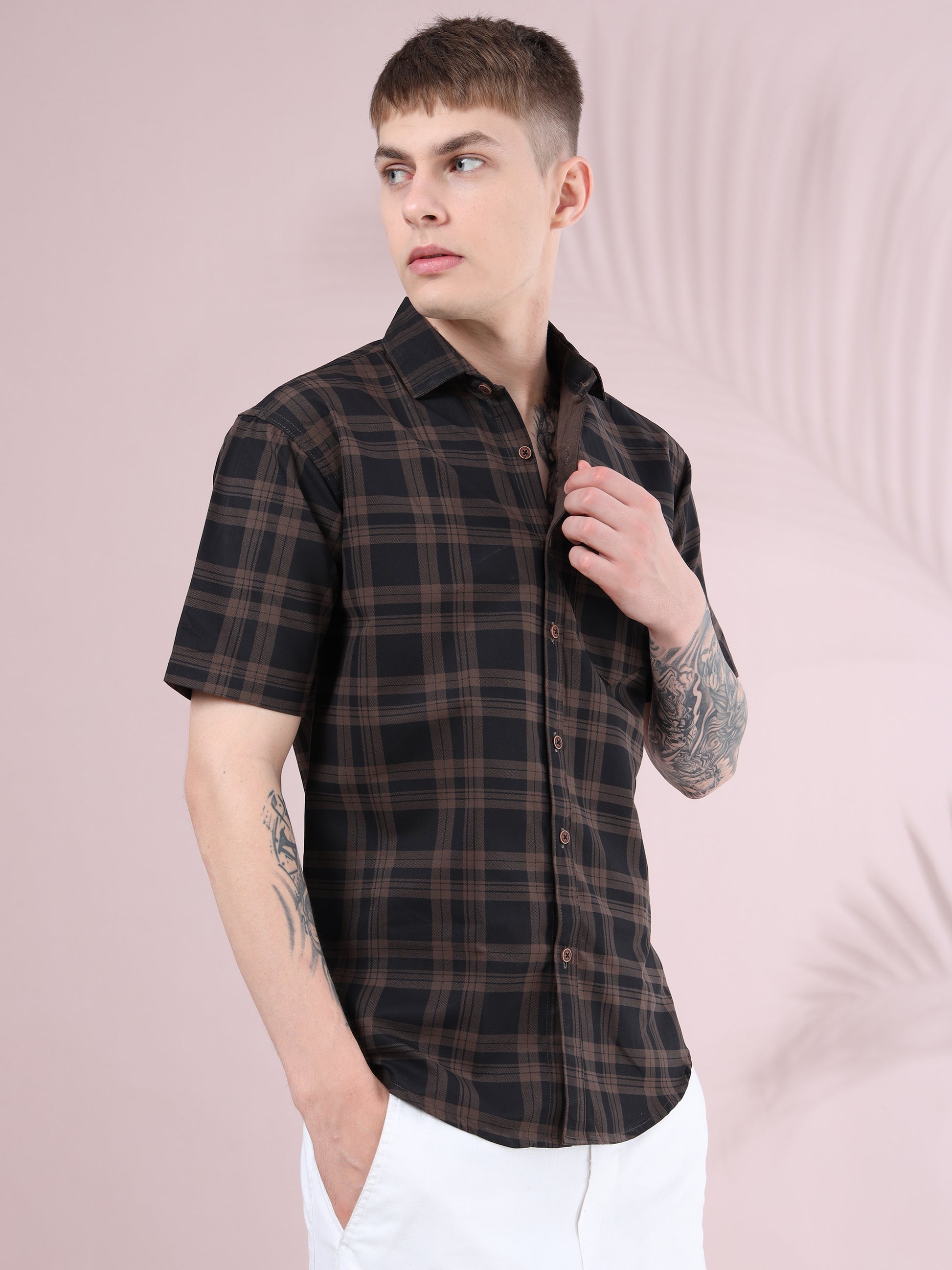 Men’s brown and black checked cotton short sleeve shirt paired with white pants.