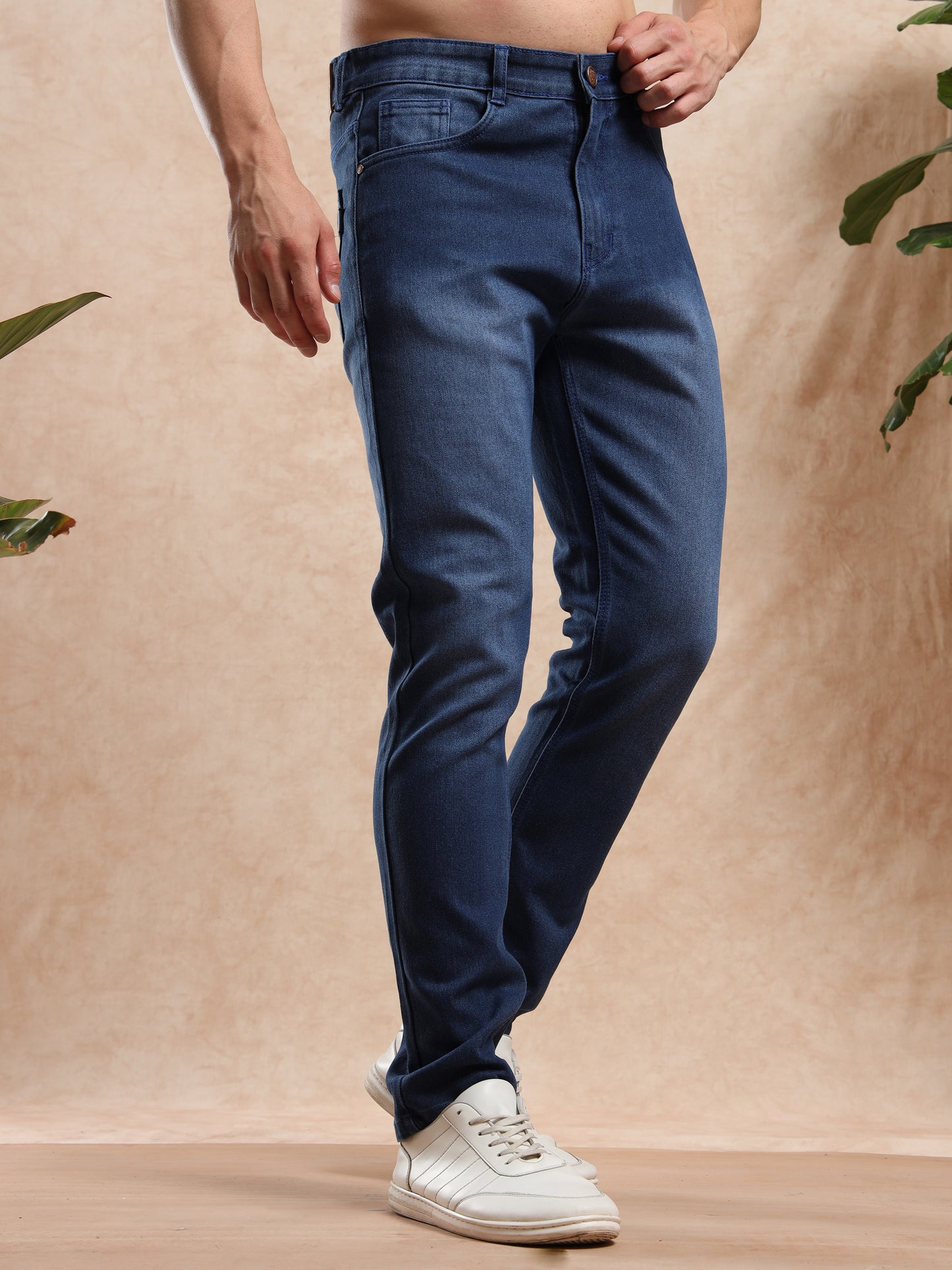 Men’s slim fit mid blue denim jeans styled with printed shirt and sneakers – casual wear look