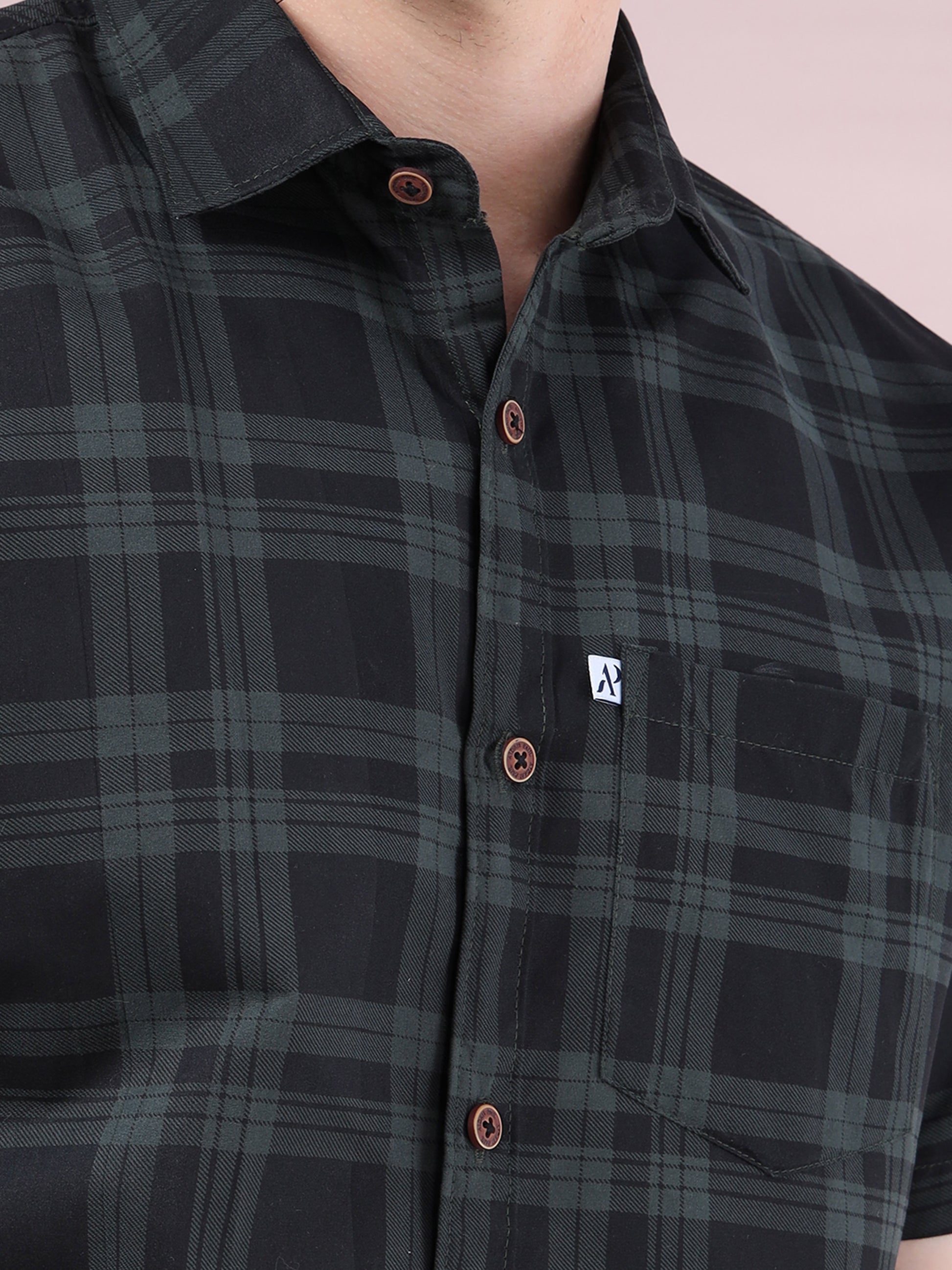 Close-up of black checkered casual men’s shirt with pocket detail