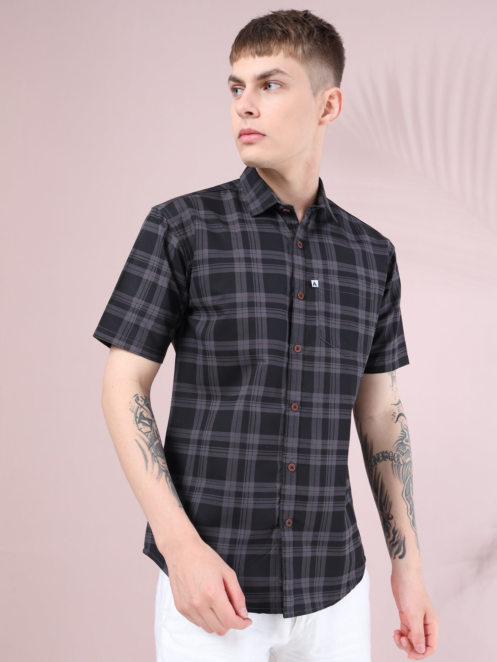 Smart casual men’s short sleeve check shirt styled with white trousers.