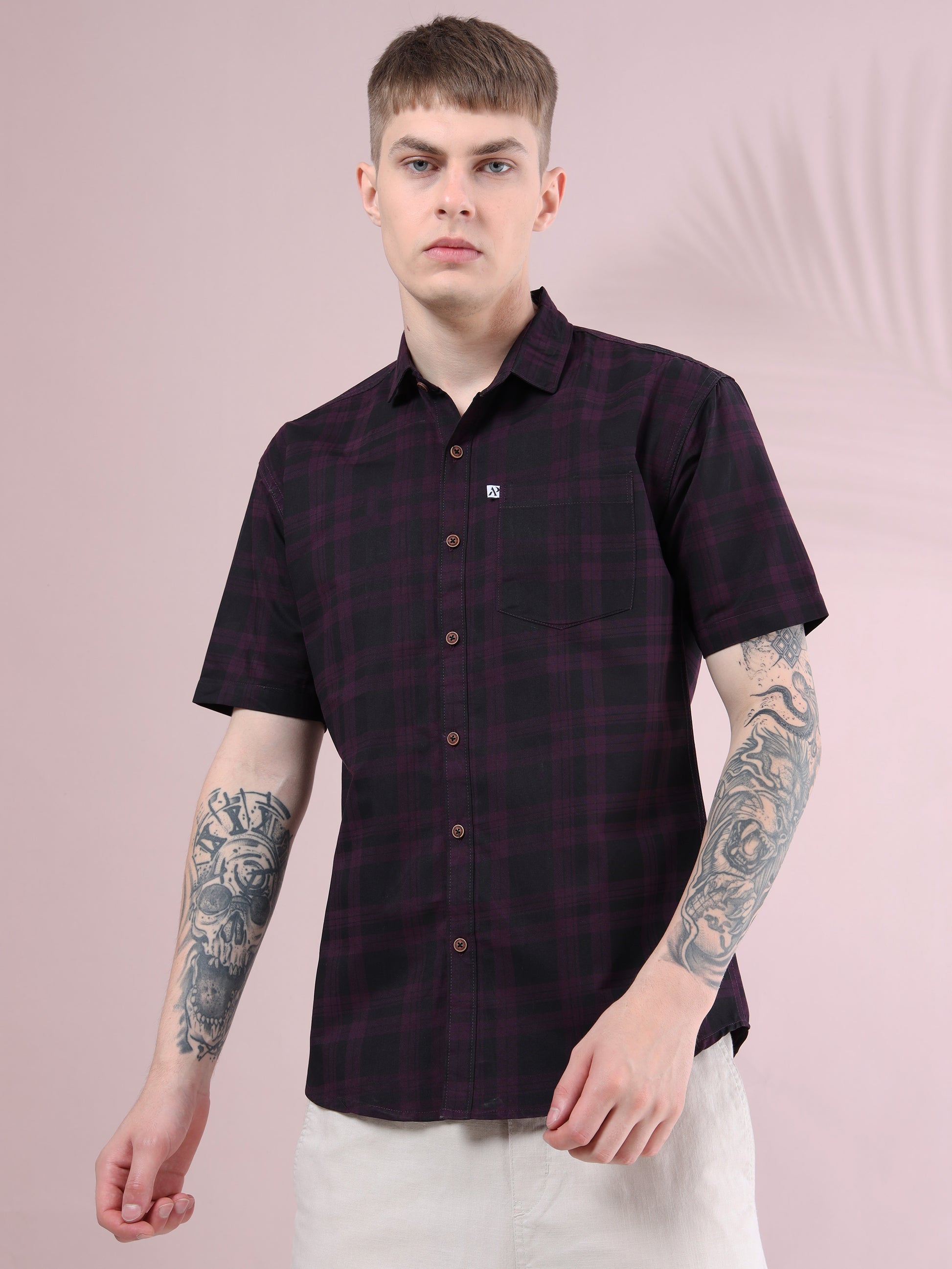 Front view of men’s purple & black checkered slim fit short sleeve shirt paired with beige trousers.