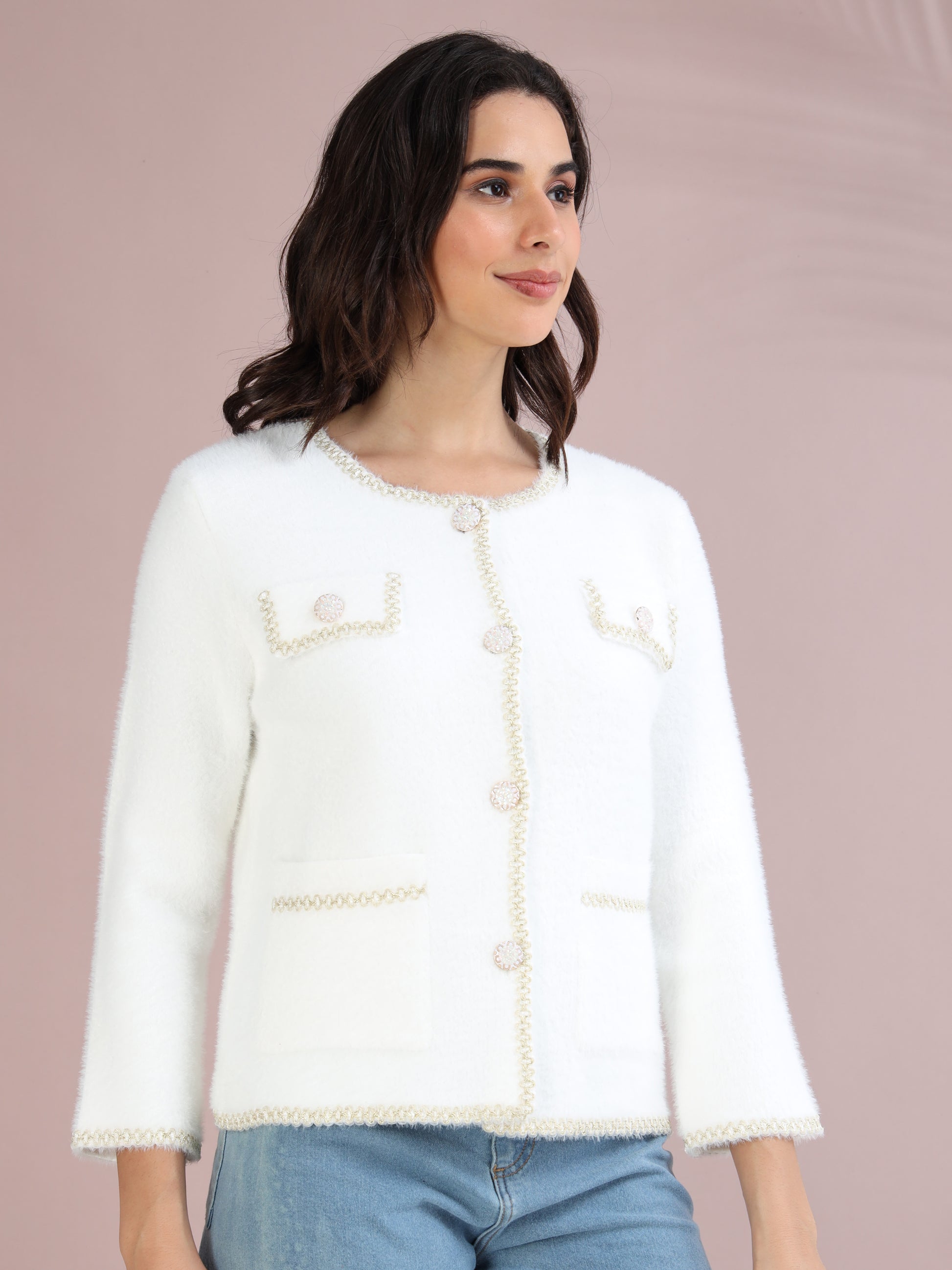 women’s cardigan with pearl button detailing and long sleeves, shown from side angle.