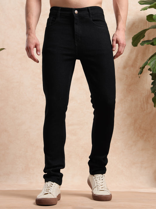 Front view of men's slim fit black jeans styled with white sneakers