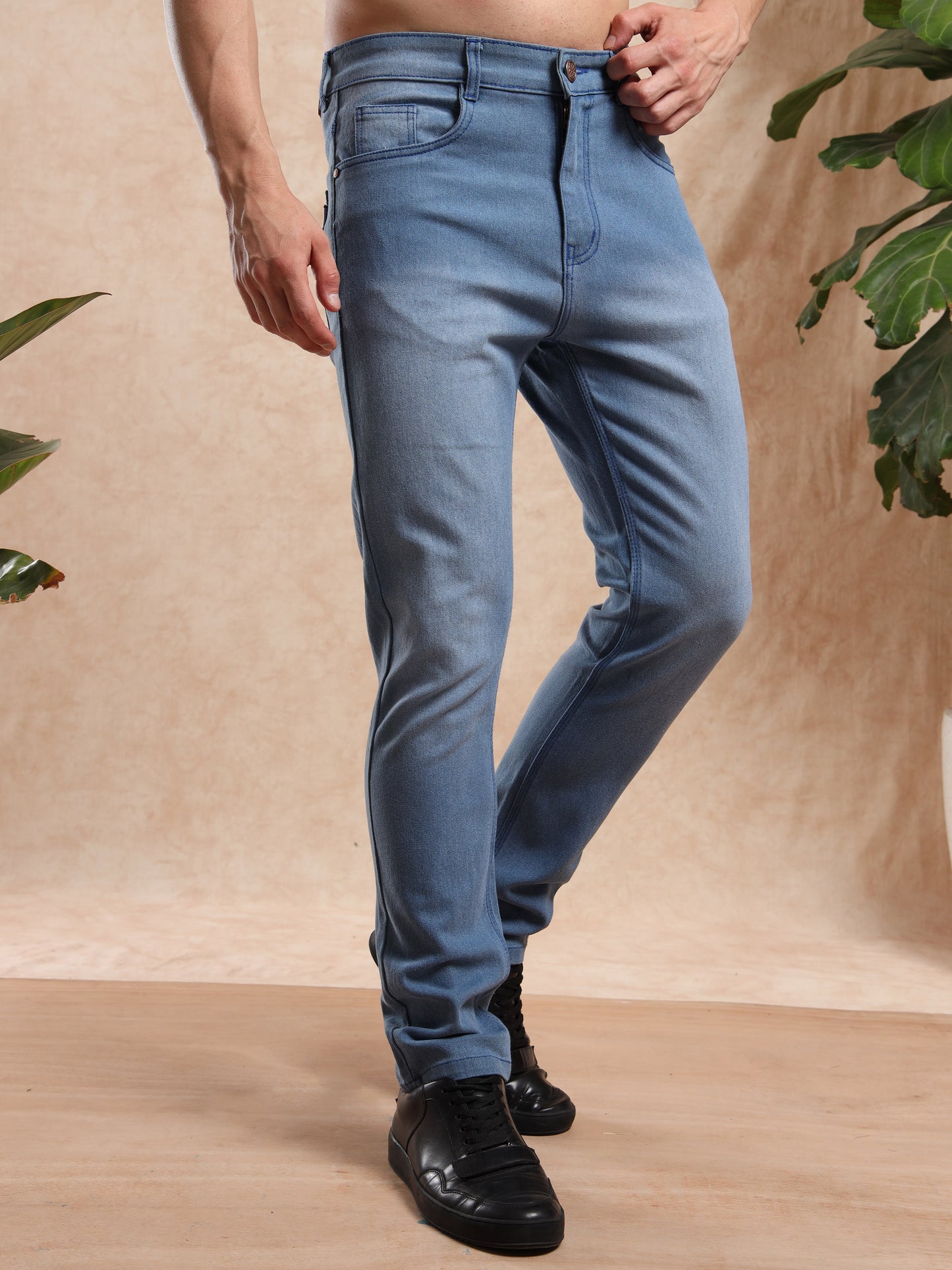 Trendy slim fit stretch denim jeans in faded blue for men.
