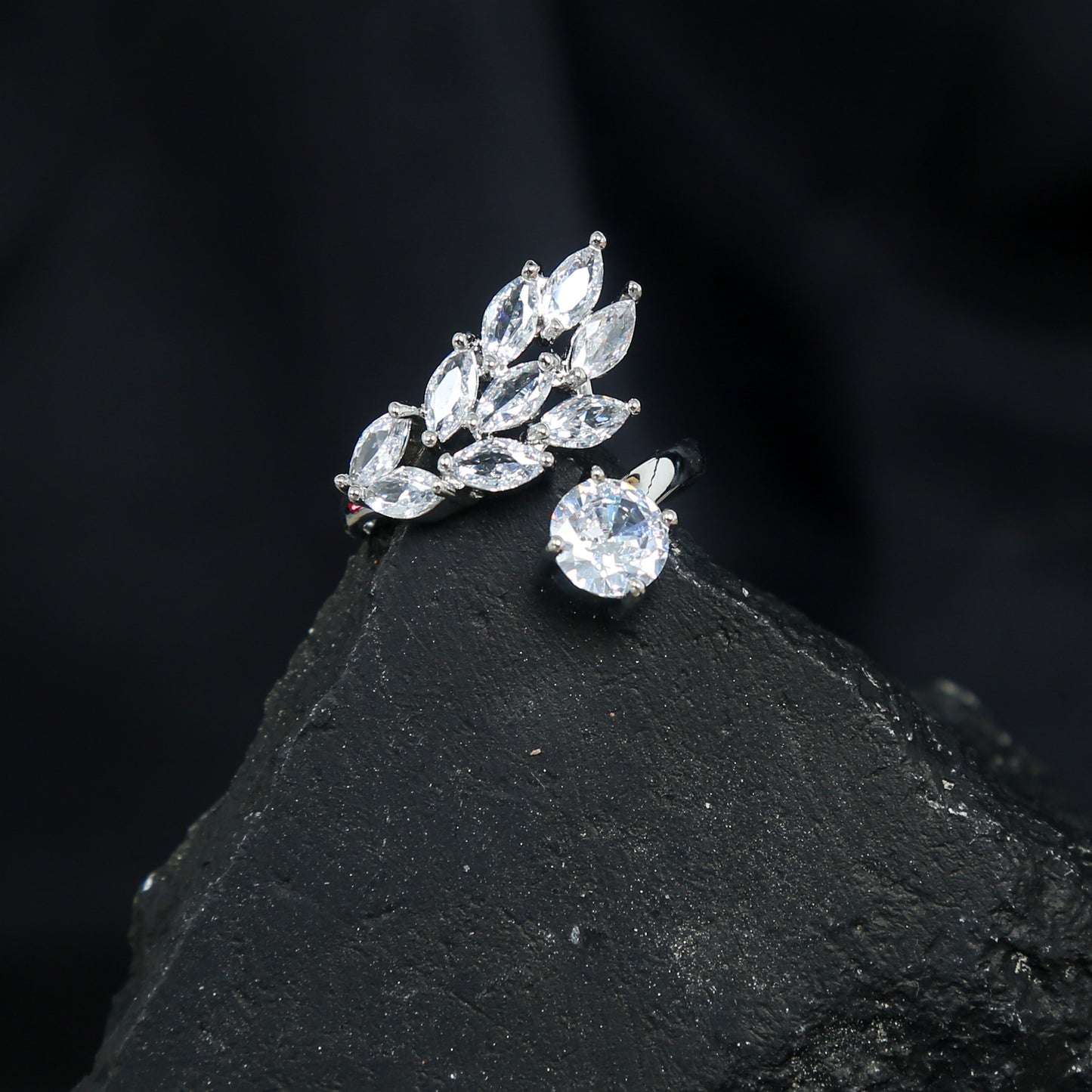 Elegant silver adjustable ring with a brilliant round zirconic stone and marquise-cut leaf design accent