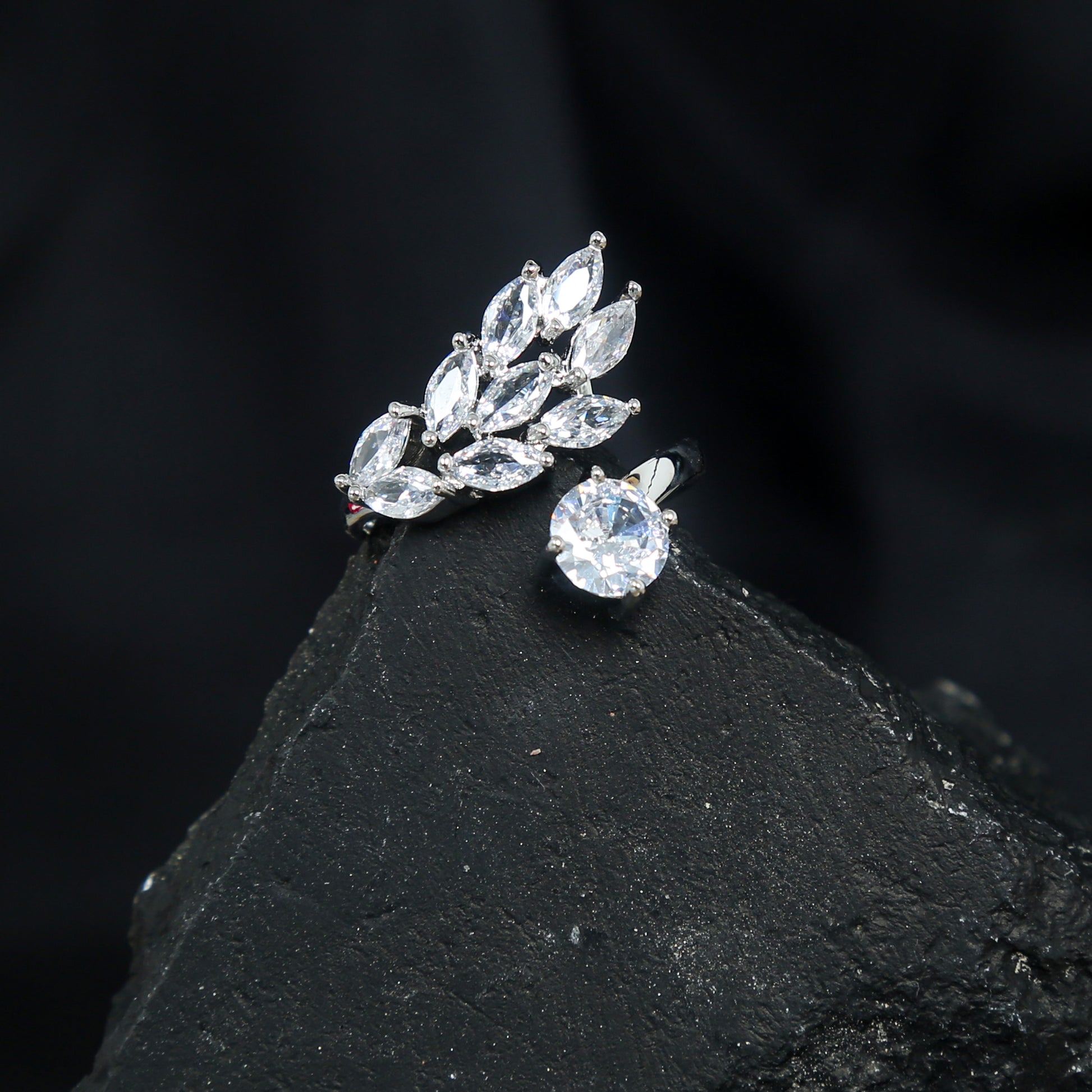 Elegant silver adjustable ring with a brilliant round zirconic stone and marquise-cut leaf design accent