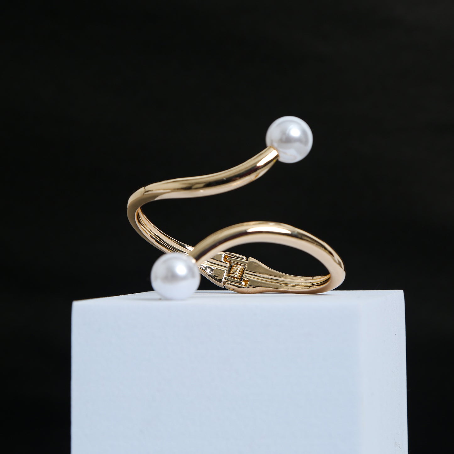 Elegant gold-plated open cuff bracelet featuring twin white pearls