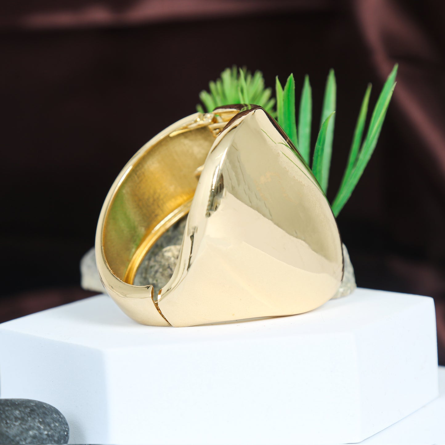 Elegant gold-plated statement cuff bracelet with a bold triangular face