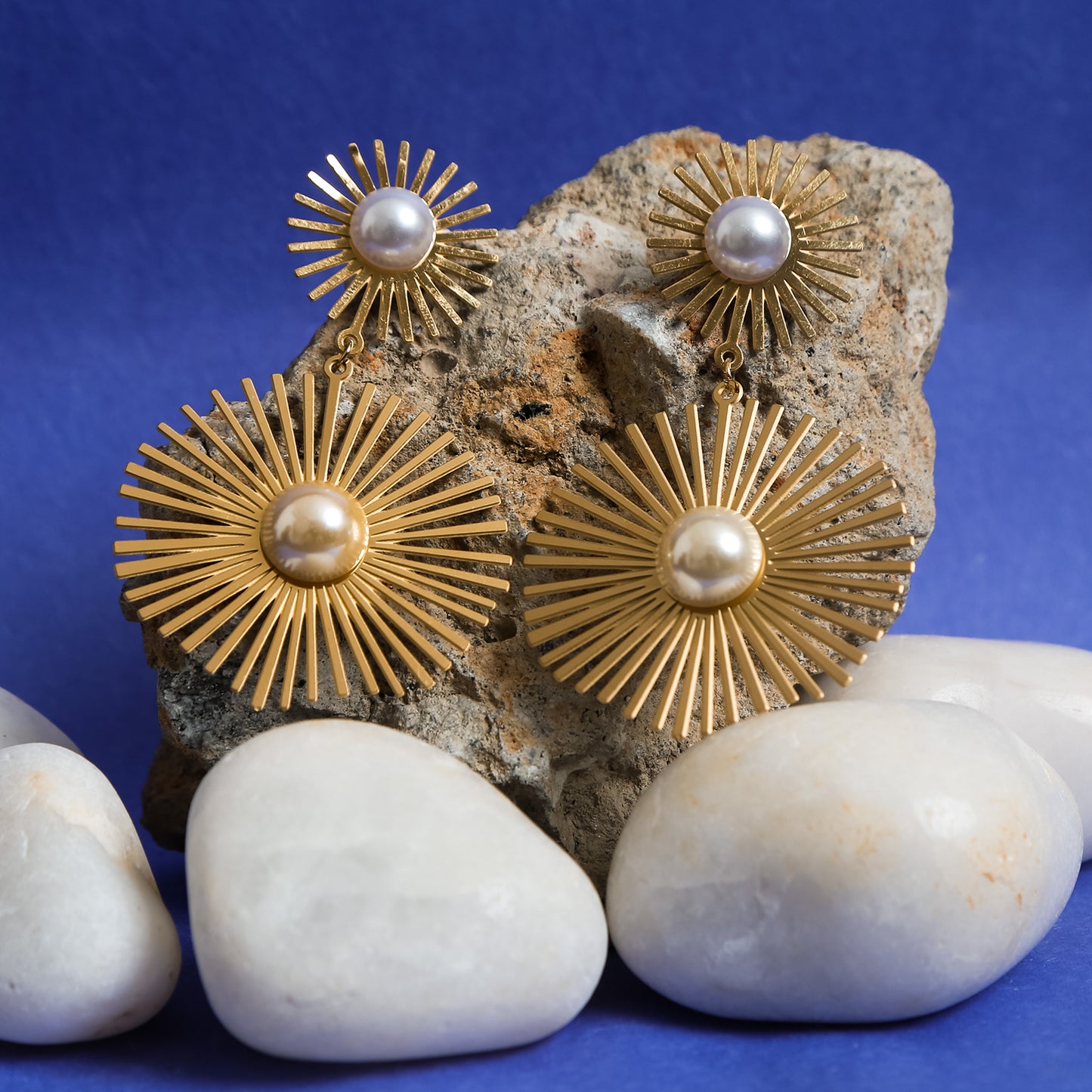 Elegant gold sunburst statement earrings with pearl center