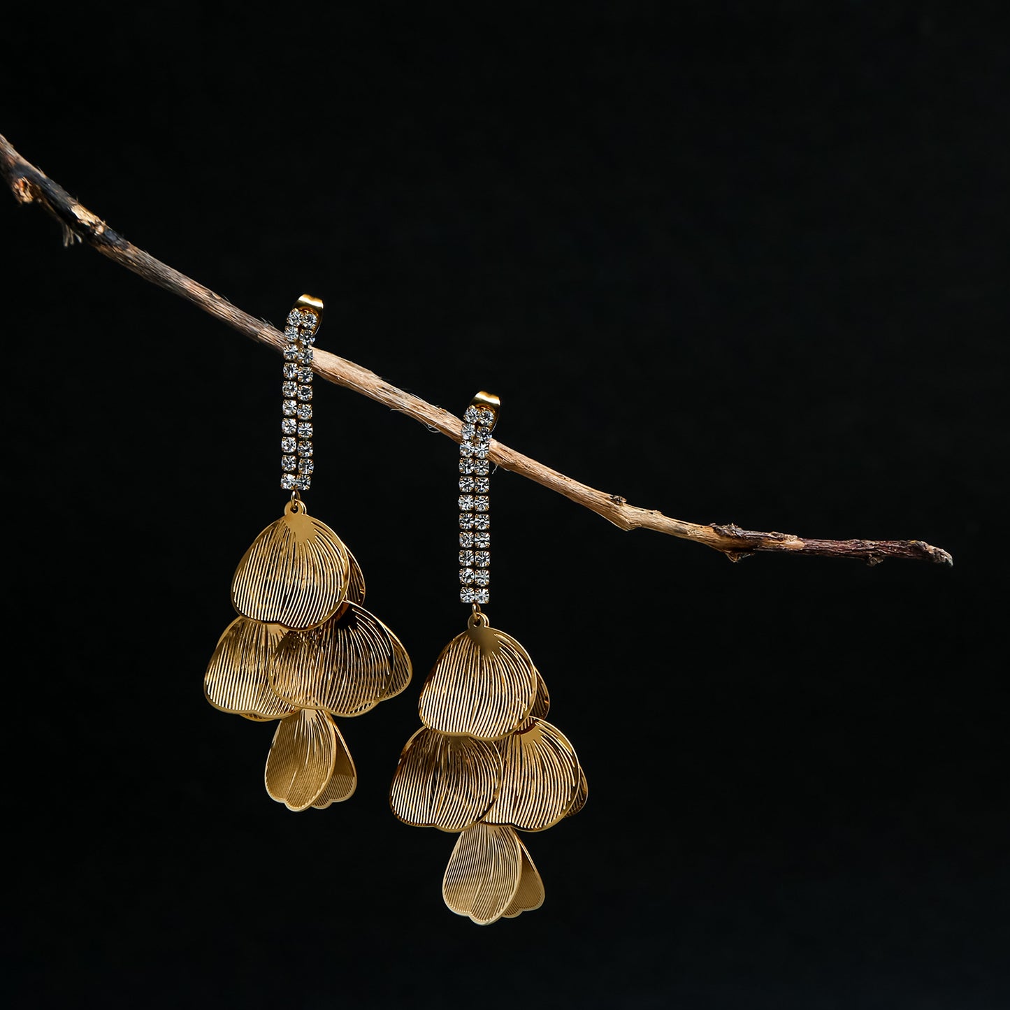 Gold petal drop earrings with layered floral design and crystal-studded hooks