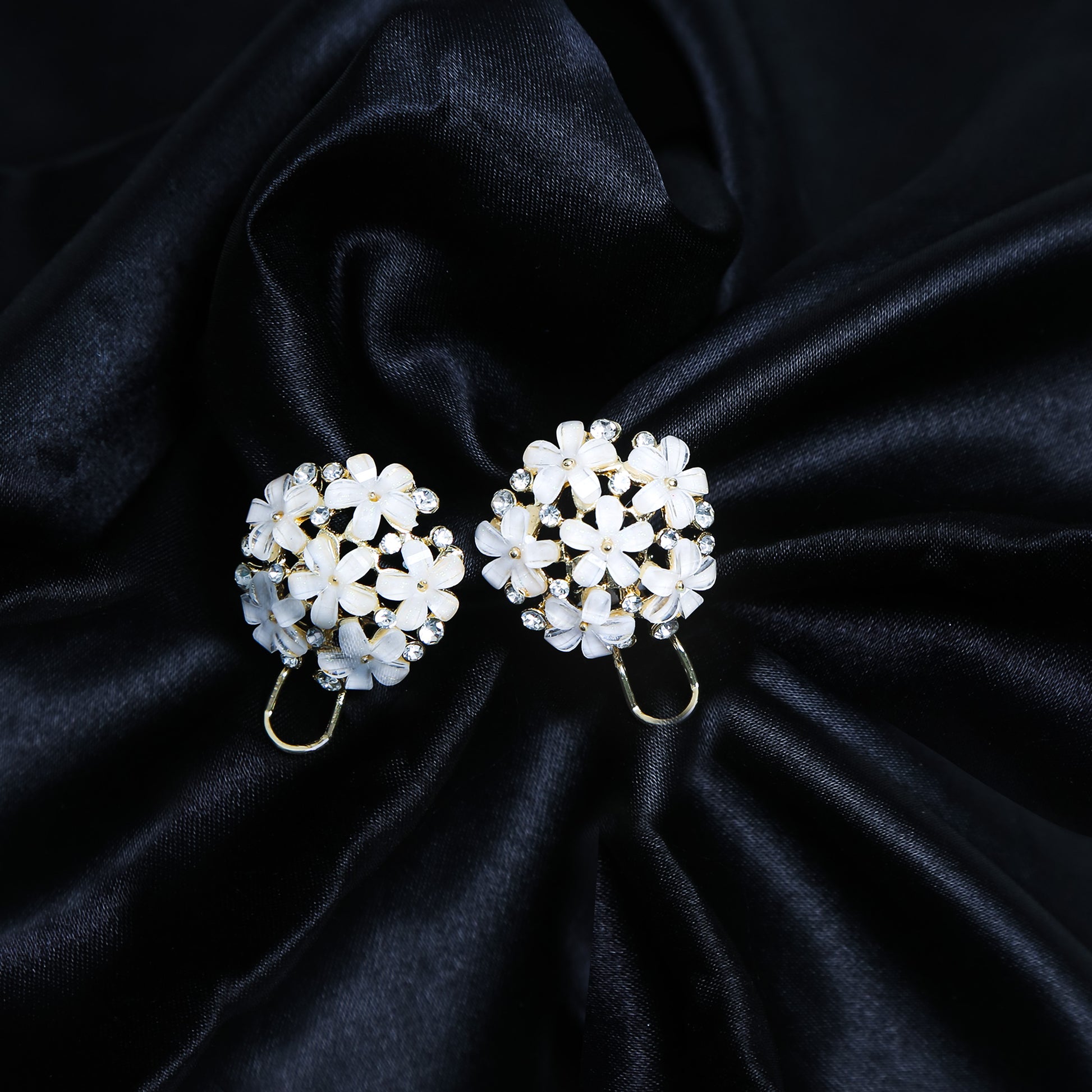 Gold-plated floral cluster earrings with white petal flowers and sparkling stones