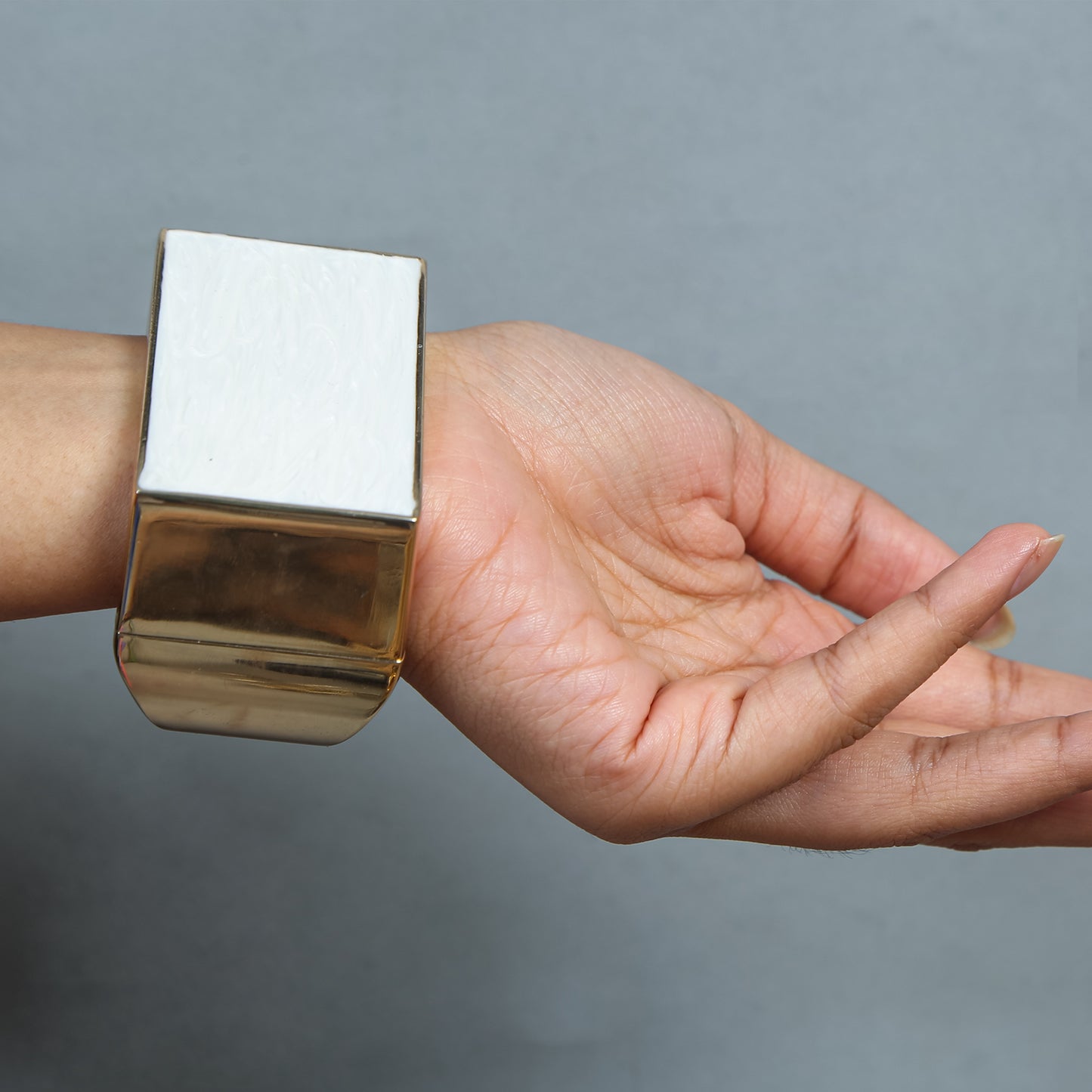 Gold-plated geometric statement bracelet with wide white enamel inlay