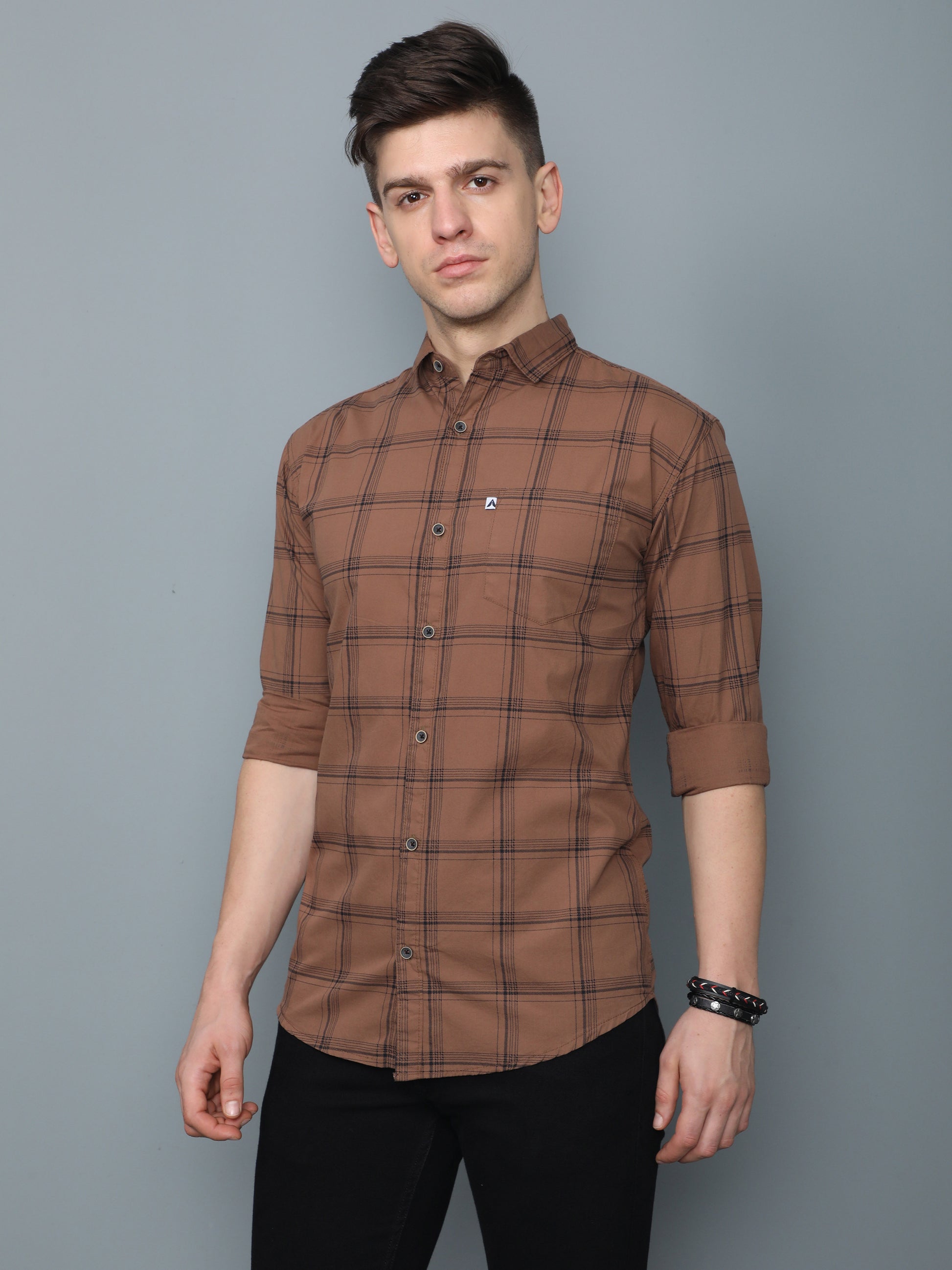 Stylish men’s brown checks shirt paired with black jeans, casual slim fit look.