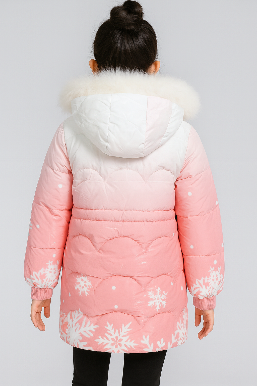 Back view of a pink winter coat with white snowflake patterns, a white-to-pink gradient hood trimmed with white faux fur