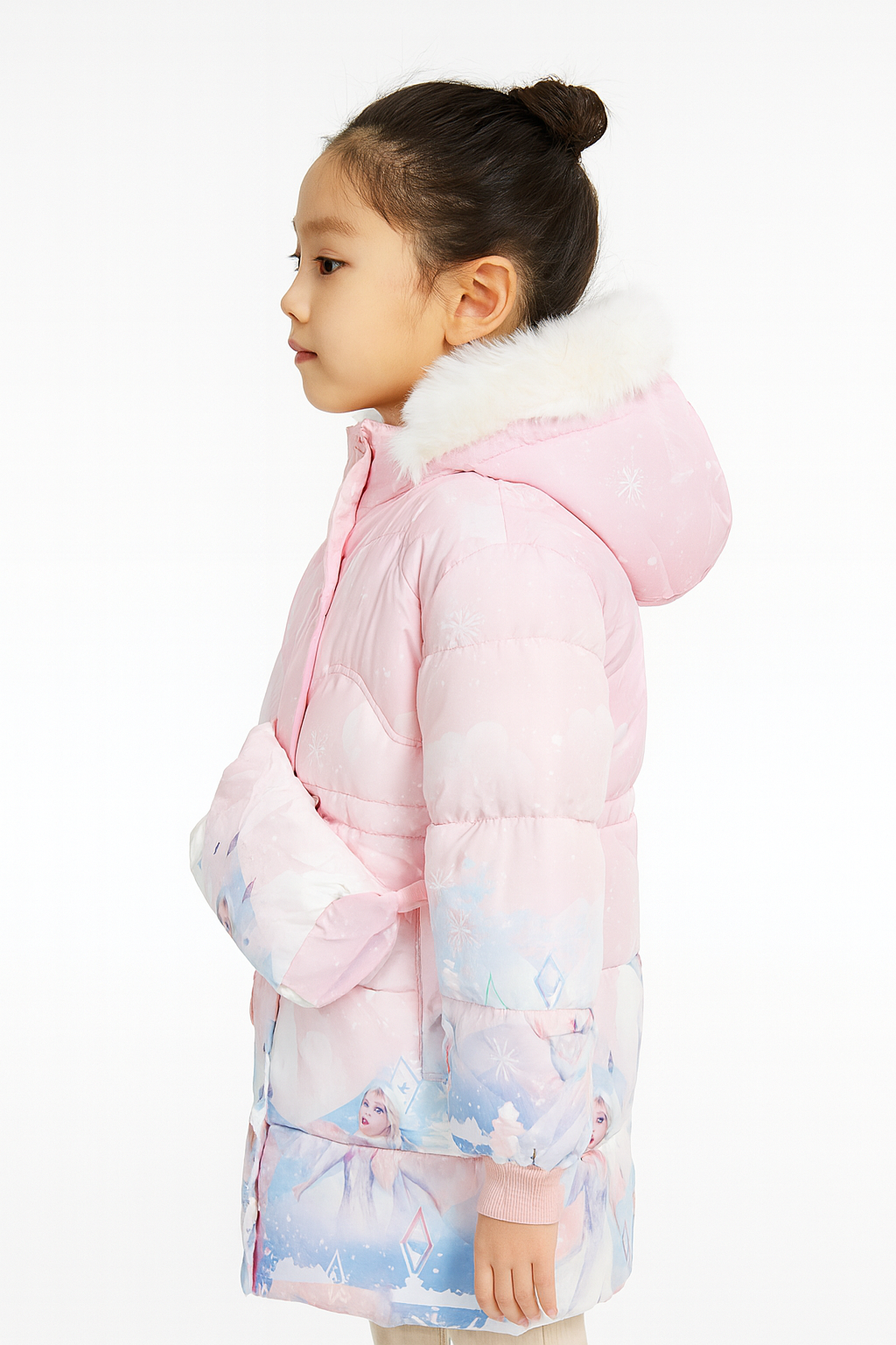 Side view of a light pink winter jacket with a white faux fur hood, featuring Frozen-themed graphics of Elsa, and carrying a matching crossbody bag.