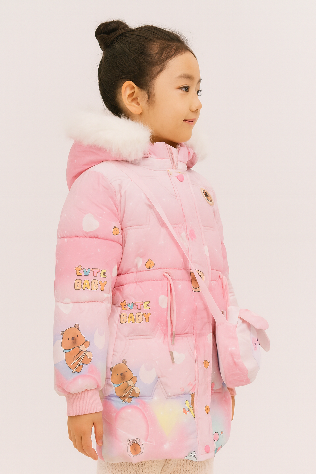 Side view of a pink winter coat with white faux fur-lined hood, decorated with bear and heart prints, "Cute Baby" text, and a matching crossbody bag shaped like a dog face.