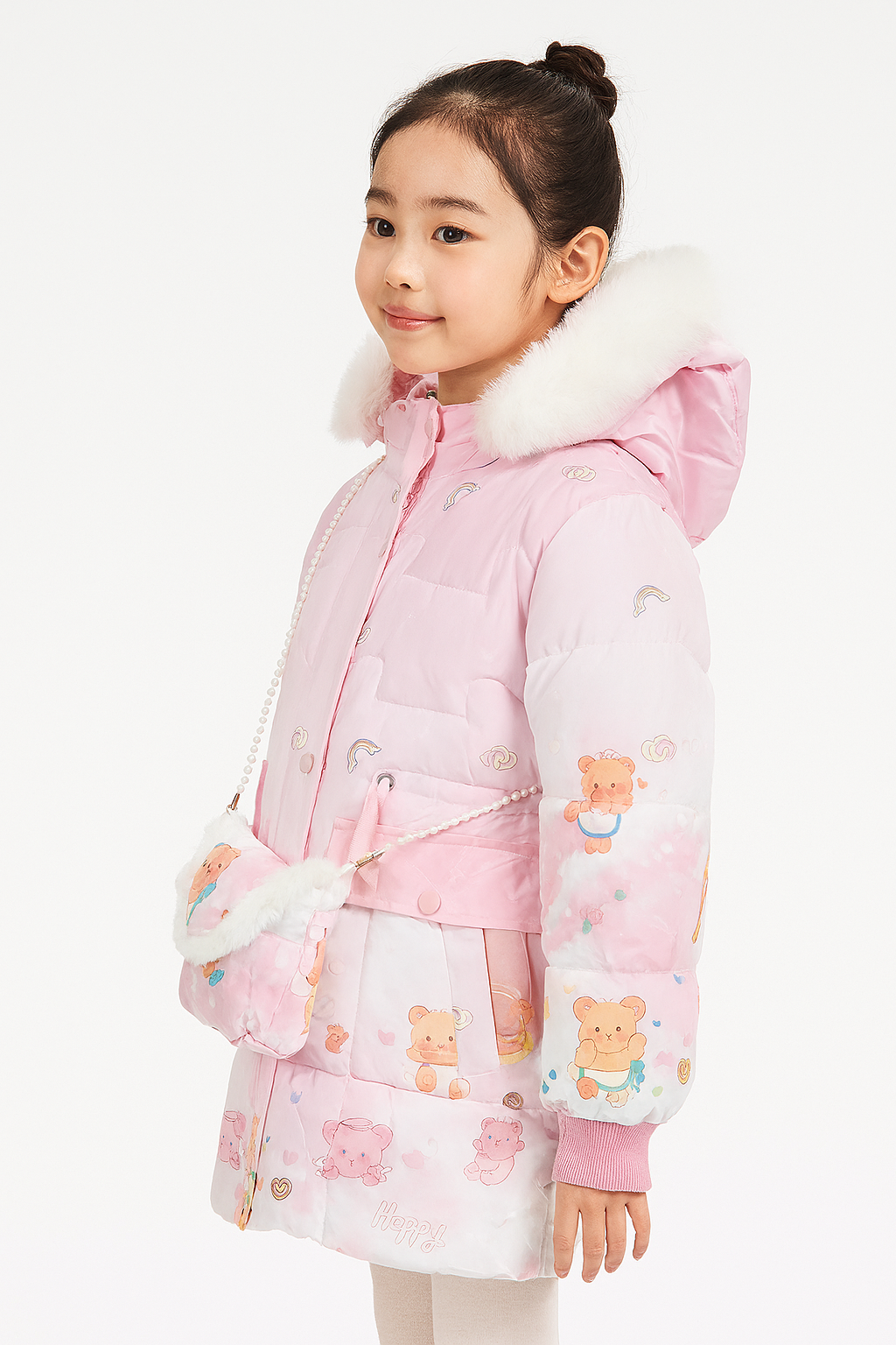 side view of a light pink winter jacket with teddy bear and rainbow prints, a white faux fur-trimmed hood, and a matching small shoulder bag with a pearl strap.
