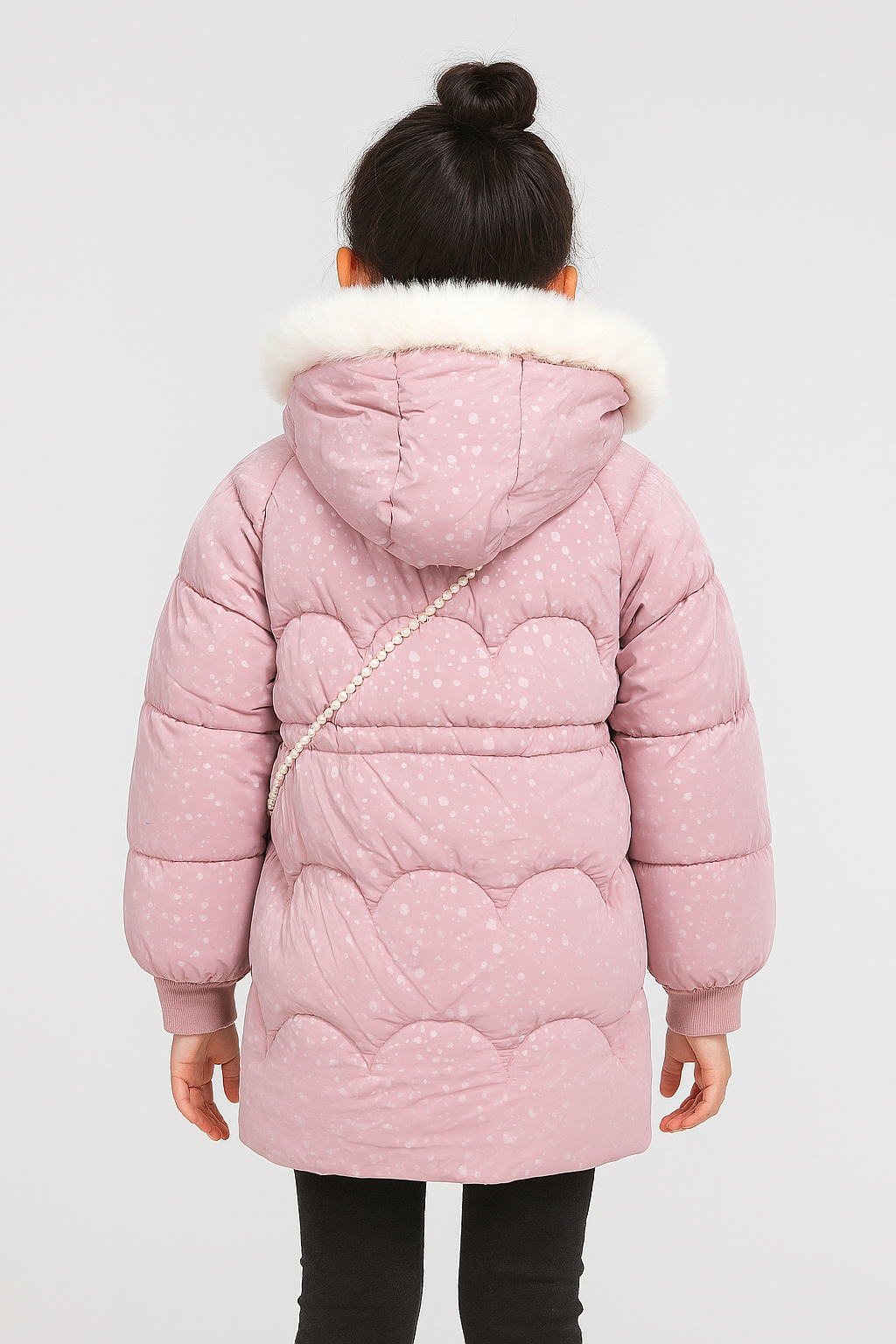Back view of  a light pink winter coat with white faux fur-trimmed hood, subtle dotted pattern, and scalloped stitching detail