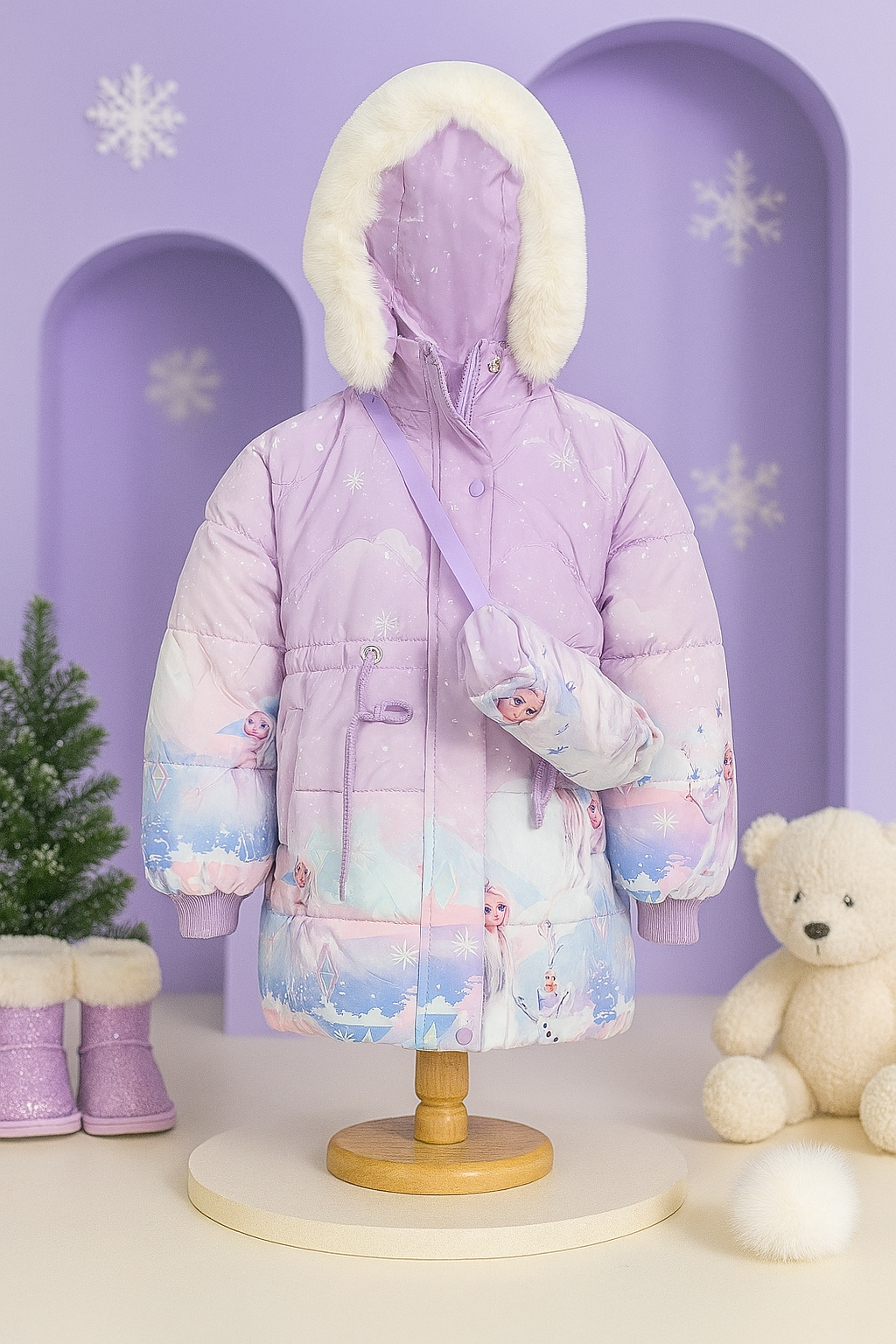 Children’s light purple puffer jacket with white faux fur hood trim, featuring Frozen character prints of Elsa and Olaf, displayed on a mannequin with a matching crossbody bag