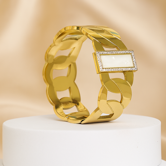 Elegant gold chain link bracelet featuring a rectangular mother of pearl stone bordered with cubic zirconia