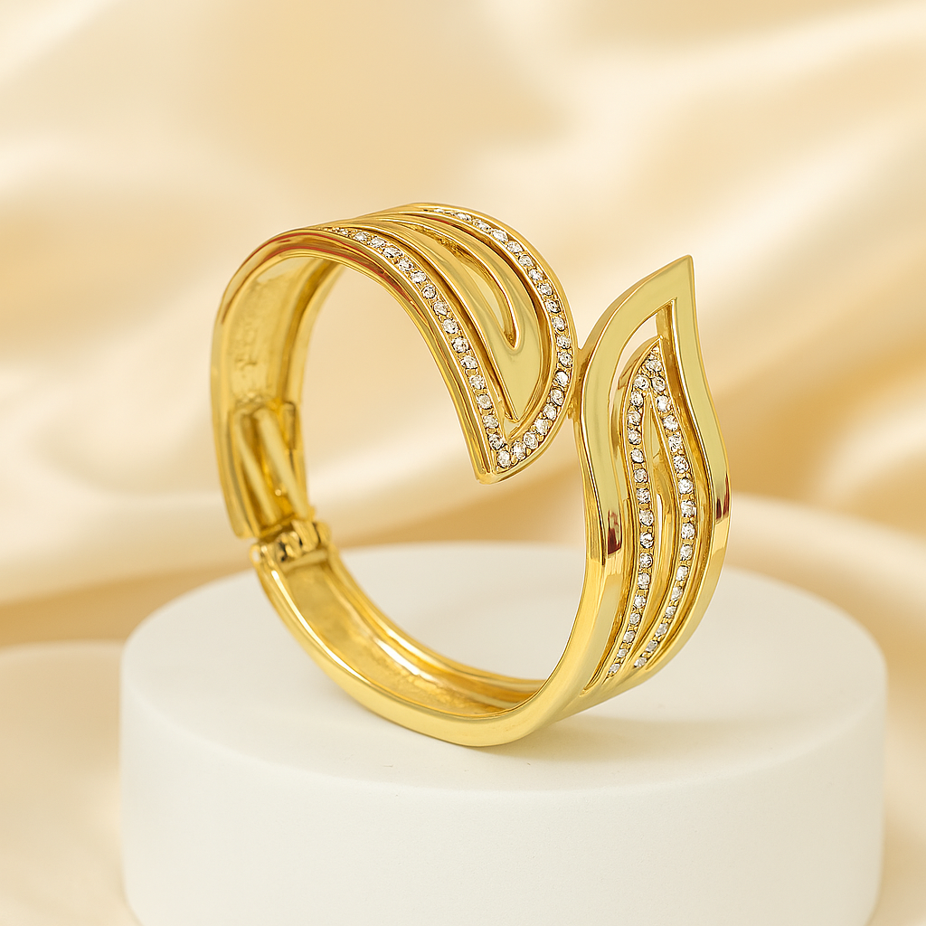 Elegant gold-plated leaf motif bracelet featuring embedded cubic zirconia stones