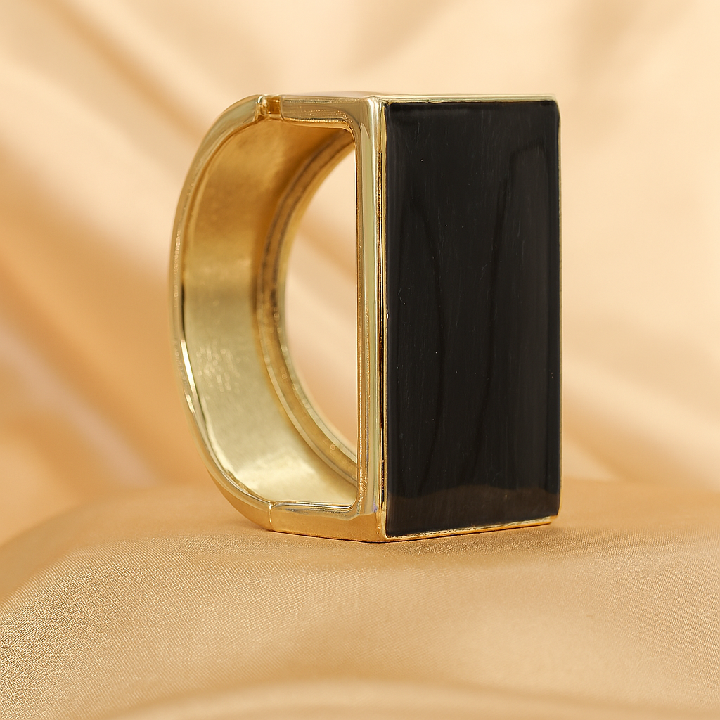 Bold statement bracelet featuring a rectangular black onyx stone set in gold plating
