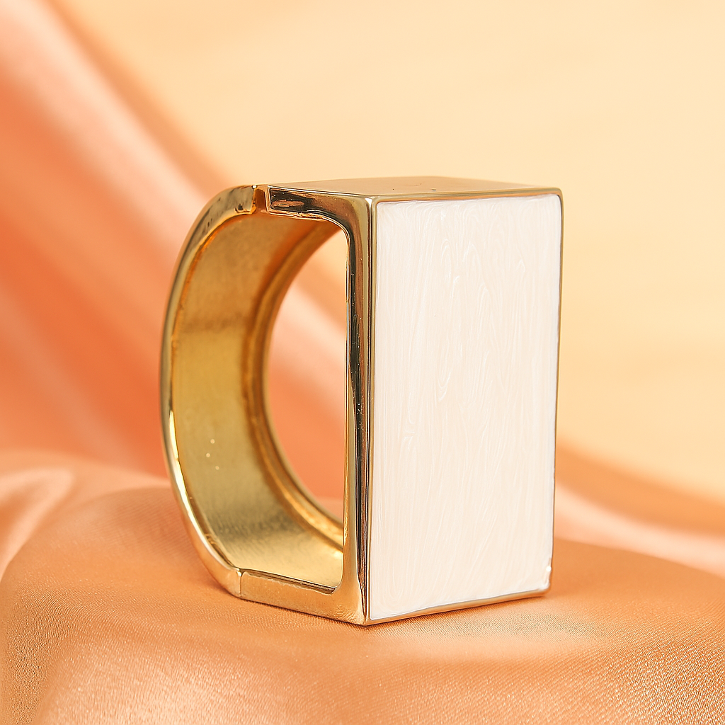 Modern gold-plated wide cuff bracelet featuring a rectangular white enamel inlay