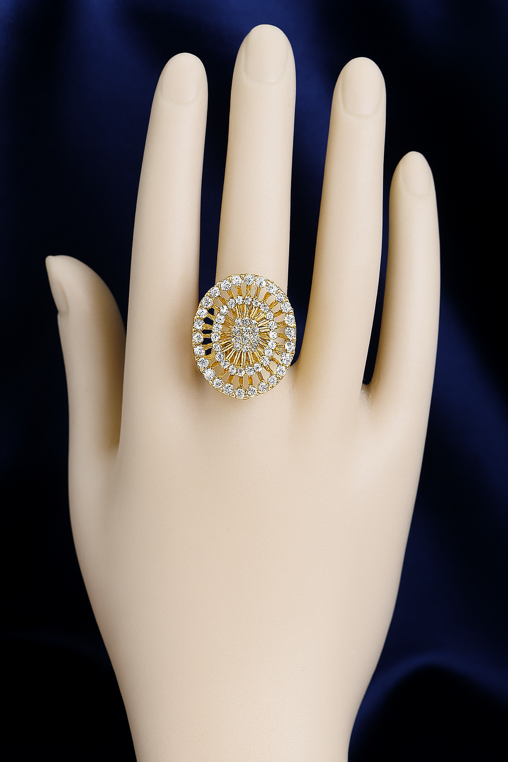 Elegant gold-plated zirconic stone statement ring with round sunburst design.