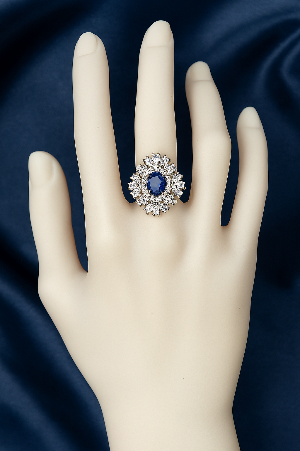 Elegant oval blue zirconic stone ring with a halo of pear-shaped