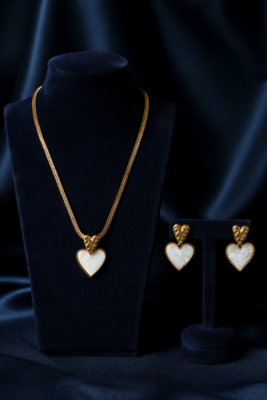 Elegant gold heart pendant necklace and matching earrings with white stone inlay