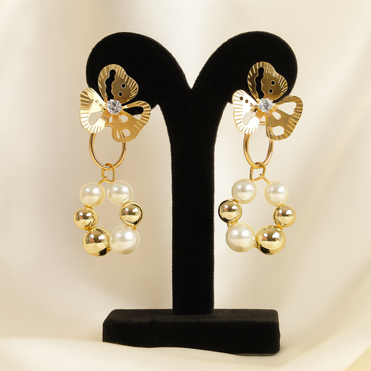 Elegant gold floral pearl drop earrings featuring flower studs with crystals and circular pearl-gold bead design