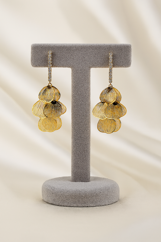 Elegant gold petal drop earrings featuring layered floral dangles and crystal-stone hooks