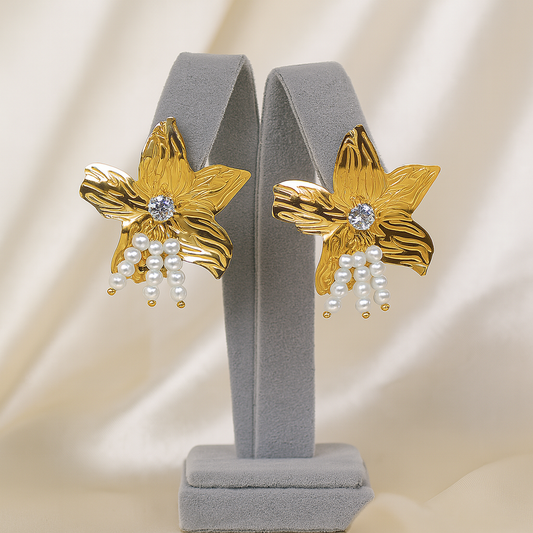 Gold floral stud earrings with sparkling stone and pearl drops