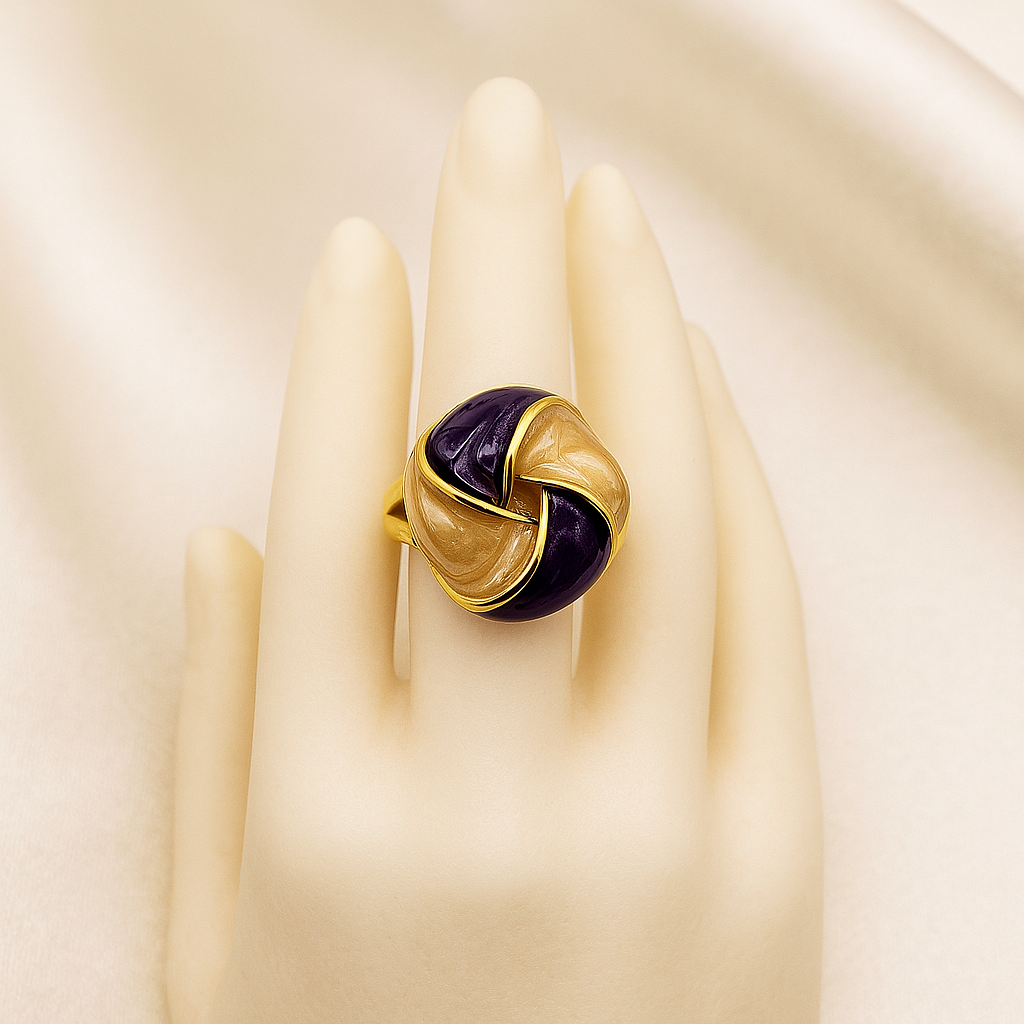 Gold-plated purple and champagne enamel knot ring displayed on a mannequin
