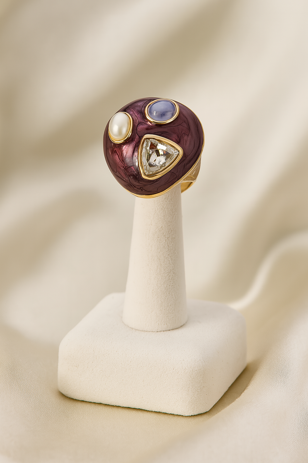 Elegant gold-plated statement ring with maroon enamel, pearl, blue gemstone, and diamond-cut crystal