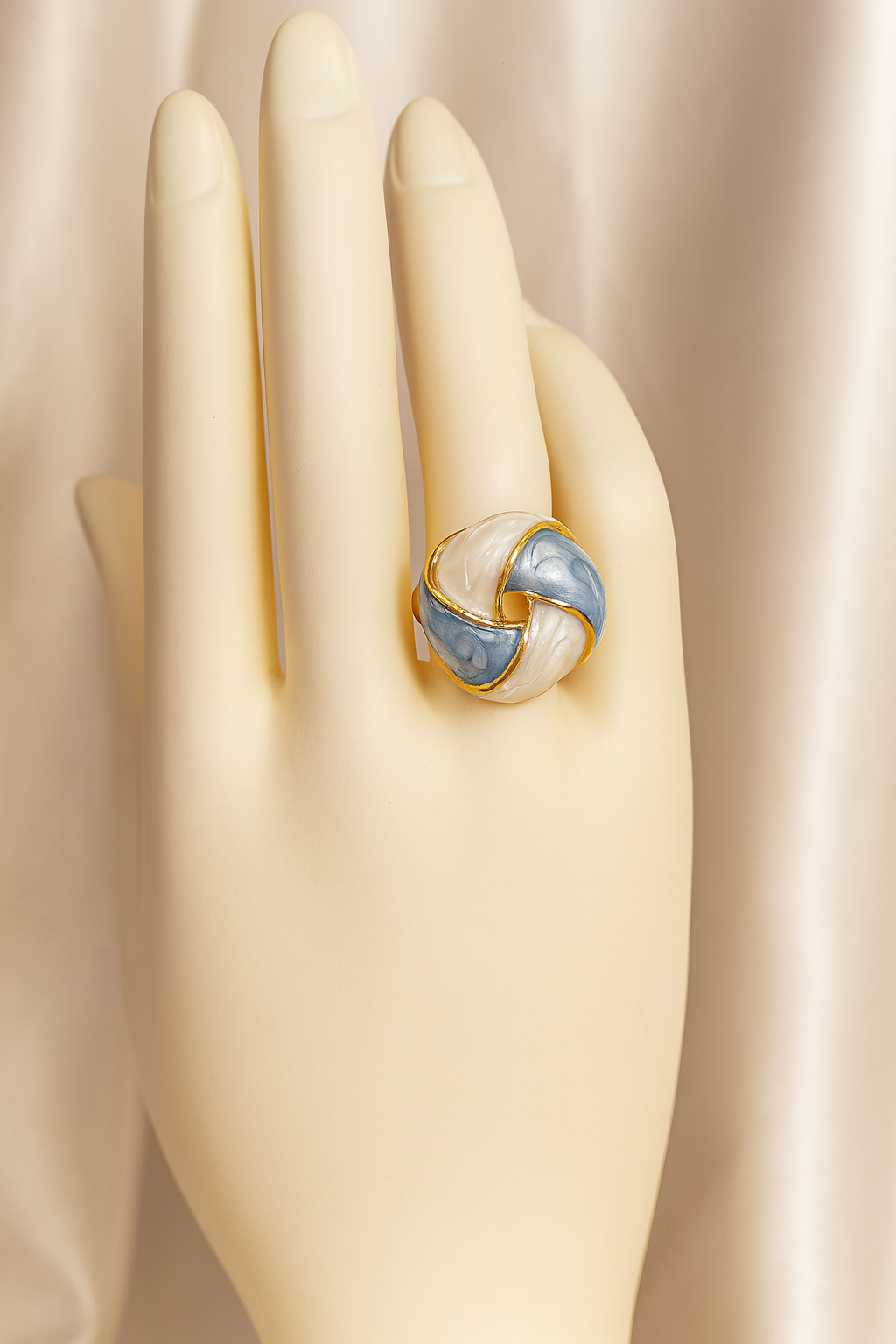 Elegant blue and white enamel gold-plated ring showcased on a mannequin