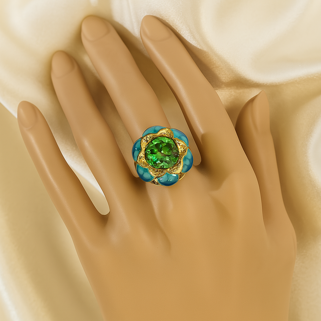 Gold-plated floral ring with a green gemstone and turquoise enamel petals.