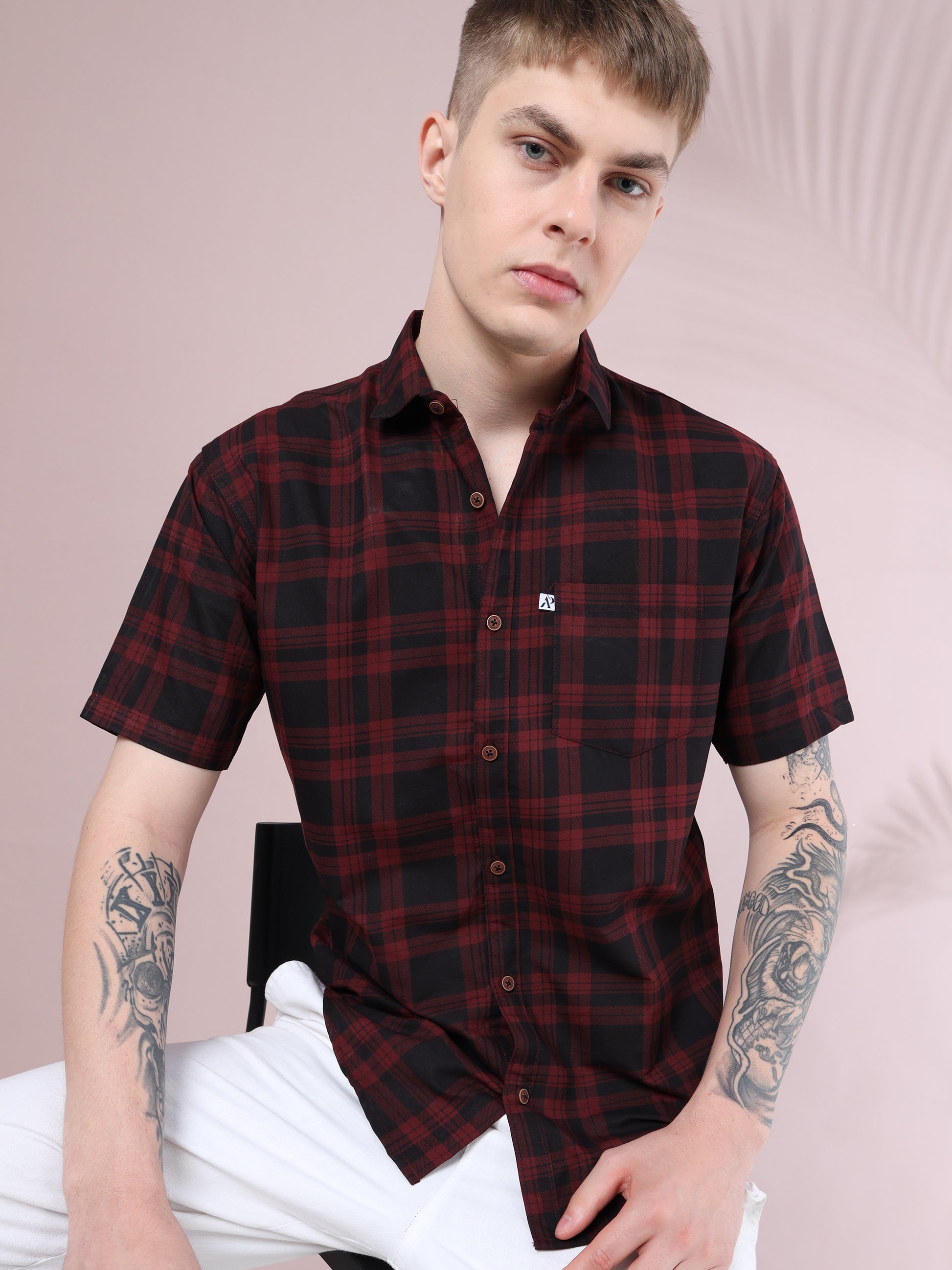 Men’s maroon and black checked short sleeve cotton shirt styled with white trousers, casual modern look
