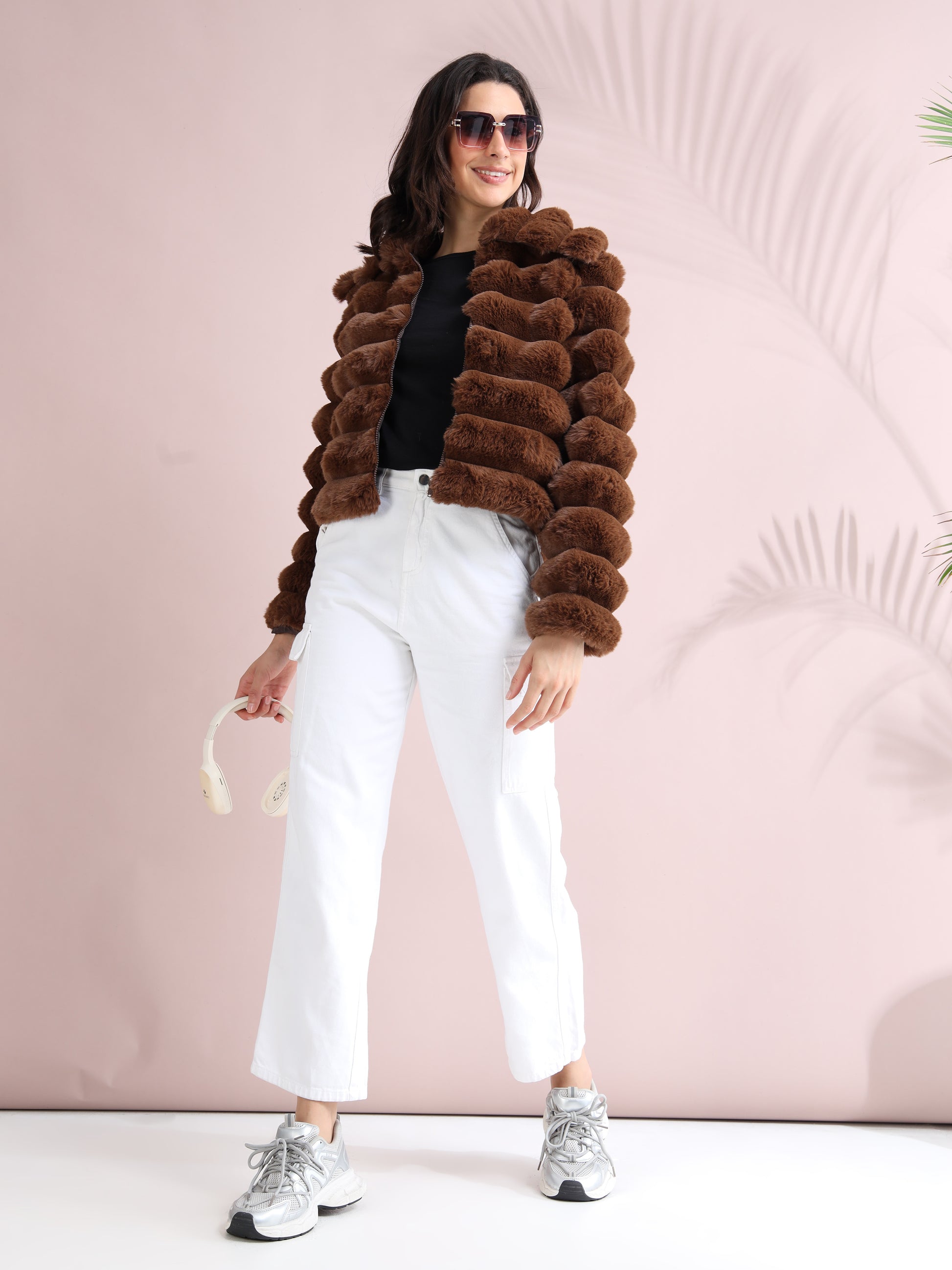 brown faux fur puffer jacket with white pants, sneakers, and sunglasses for a trendy winter outfit.