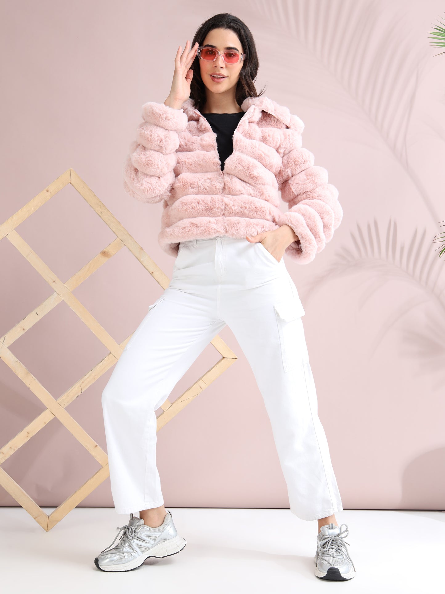 Trendy full-body look with pink faux fur jacket, white pants, and sneakers