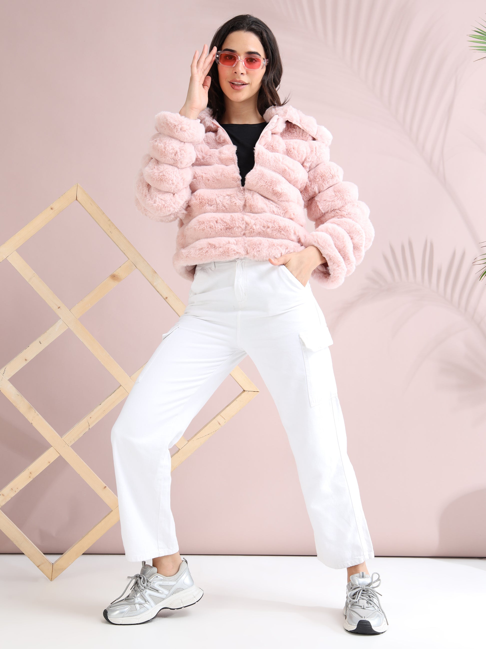 Trendy full-body look with pink faux fur jacket, white pants, and sneakers