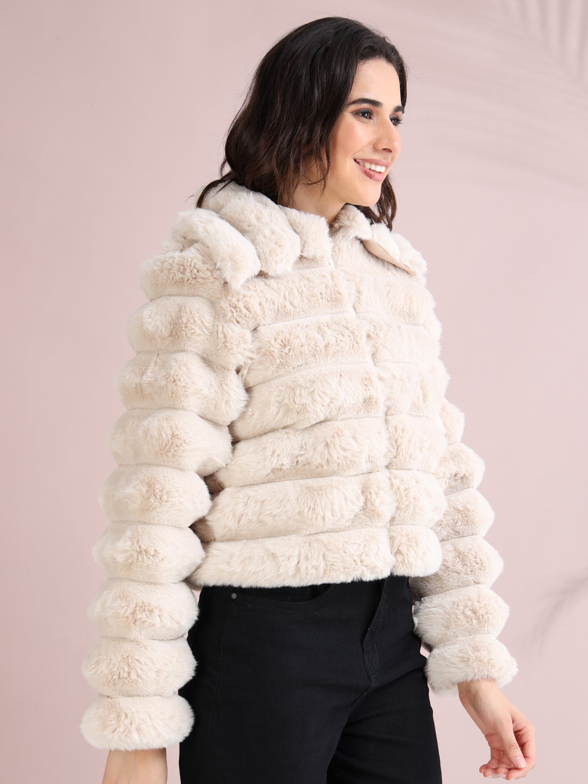 wearing beige faux fur jacket with high collar and ribbed sleeve design