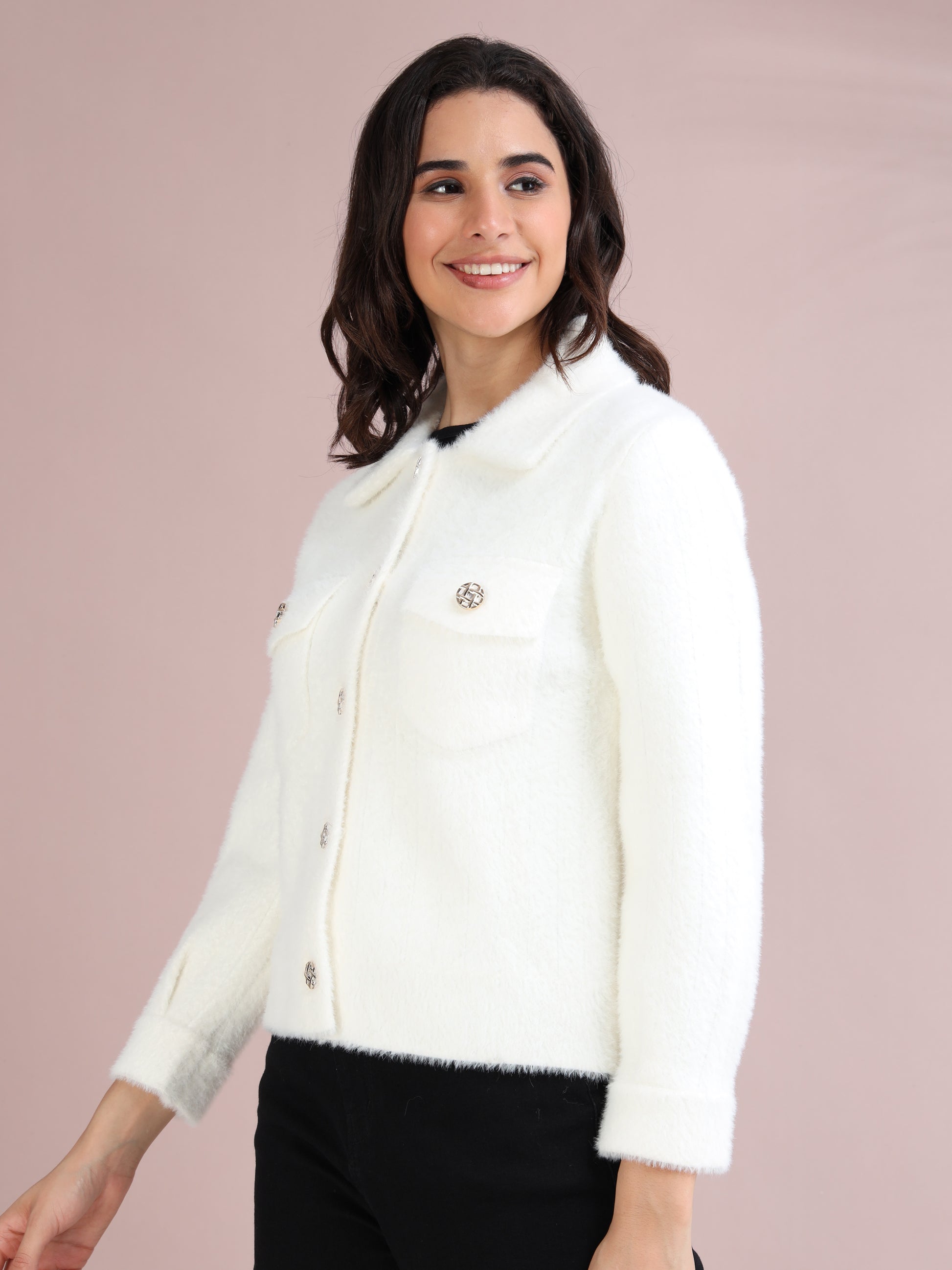Side profile of women's white collared faux fur jacket with decorative buttons and long sleeves