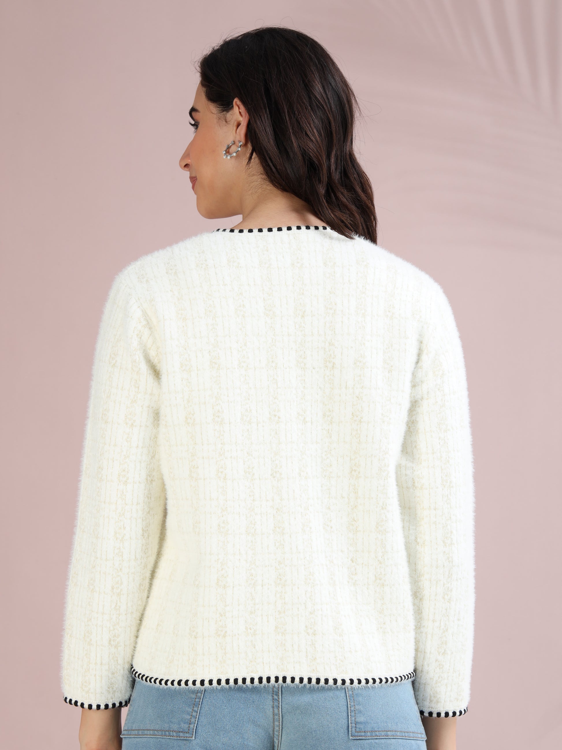 Minimalist back view of women’s white cardigan sweater with clean finish and black trim.